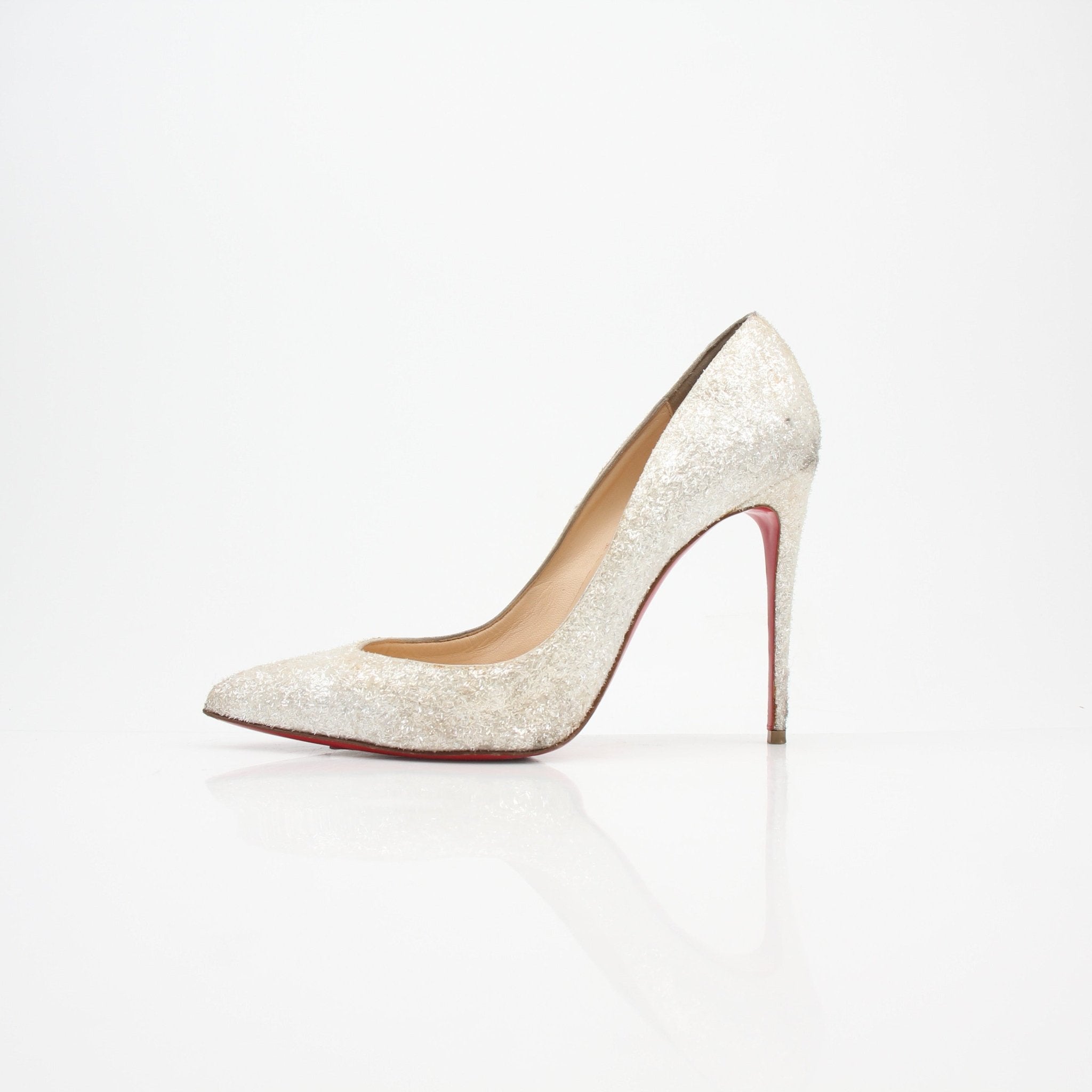 Christian Louboutin Pigalle Follies Givre glitter heels with pointed toes and stiletto heels, featuring sparkling silver embellishments.