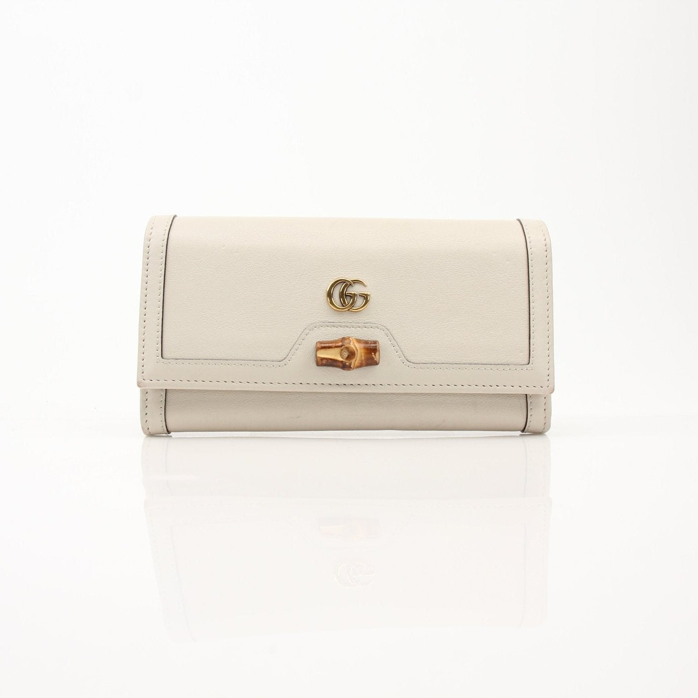 Gucci Diana Wallet by Gold & Beyond, elegant leather wallet with gold accents, featuring multiple card slots and a secure zip compartment.
