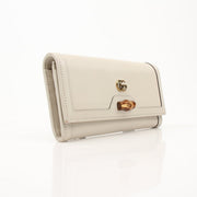 Gold & Beyond Gucci Diana Wallet with gold accents, featuring a sleek design and multiple card slots.