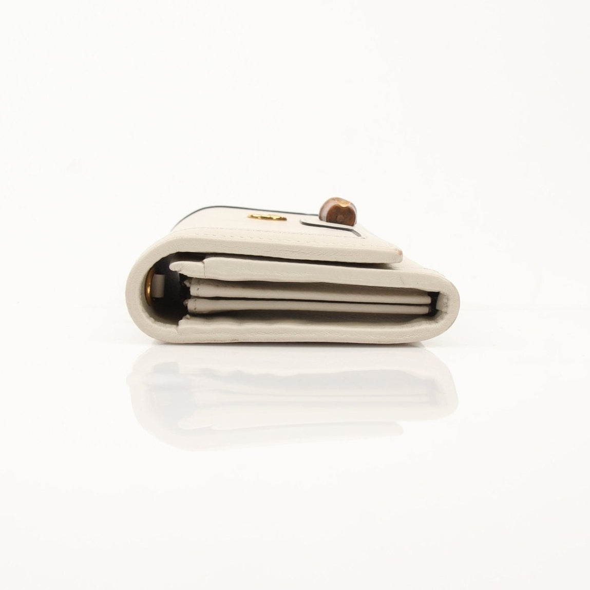 Gucci Diana Wallet by Gold & Beyond featuring a sleek design with gold accents and multiple card slots.