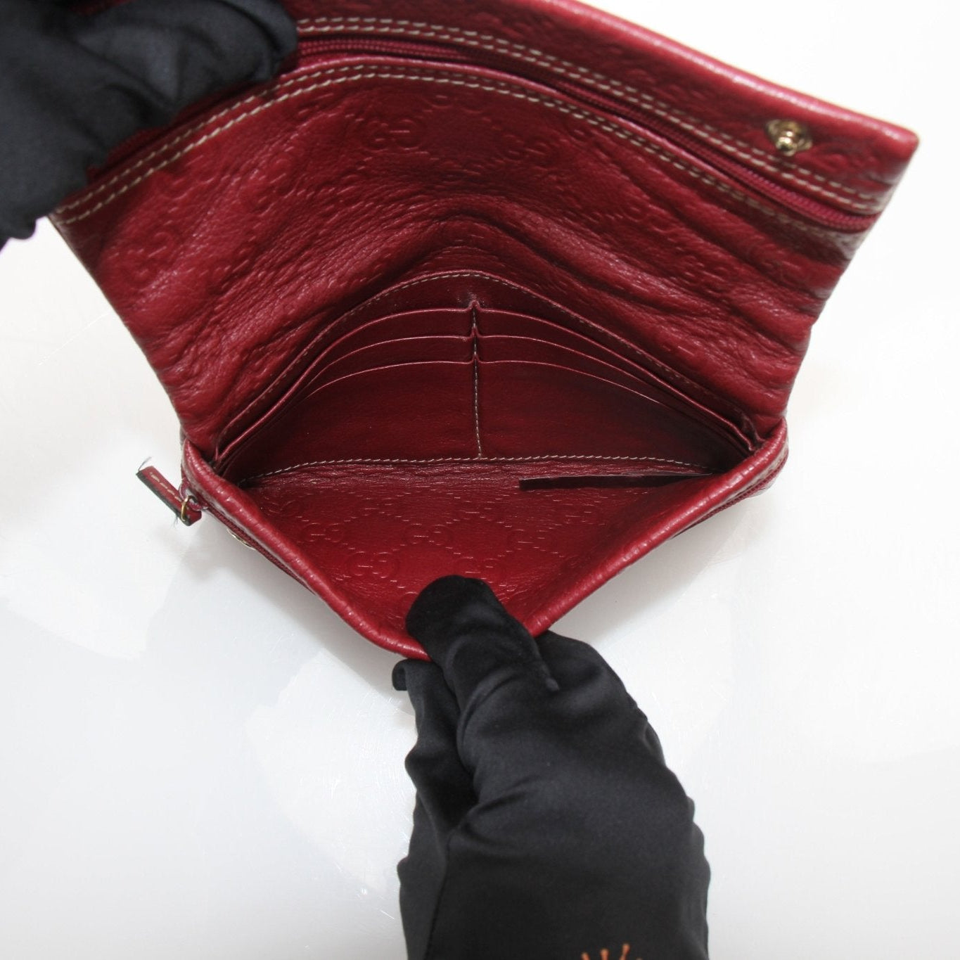 Gucci Guccissima continental wallet by Gold & Beyond, featuring classic monogram pattern and leather accents on a sleek design.