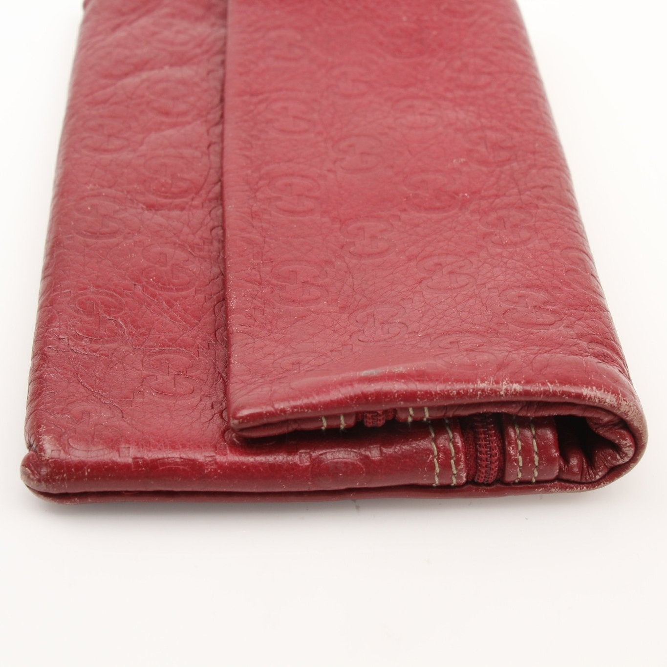 Gucci Guccissima Continental wallet with gold accents, featuring signature embossed leather and multiple card slots.