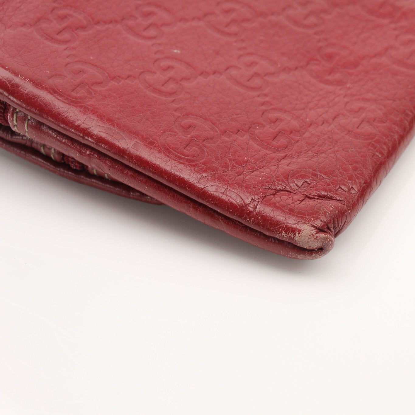 Gold & Beyond Gucci Guccissima leather continental wallet with gold accents and embossed pattern, featuring multiple card slots.