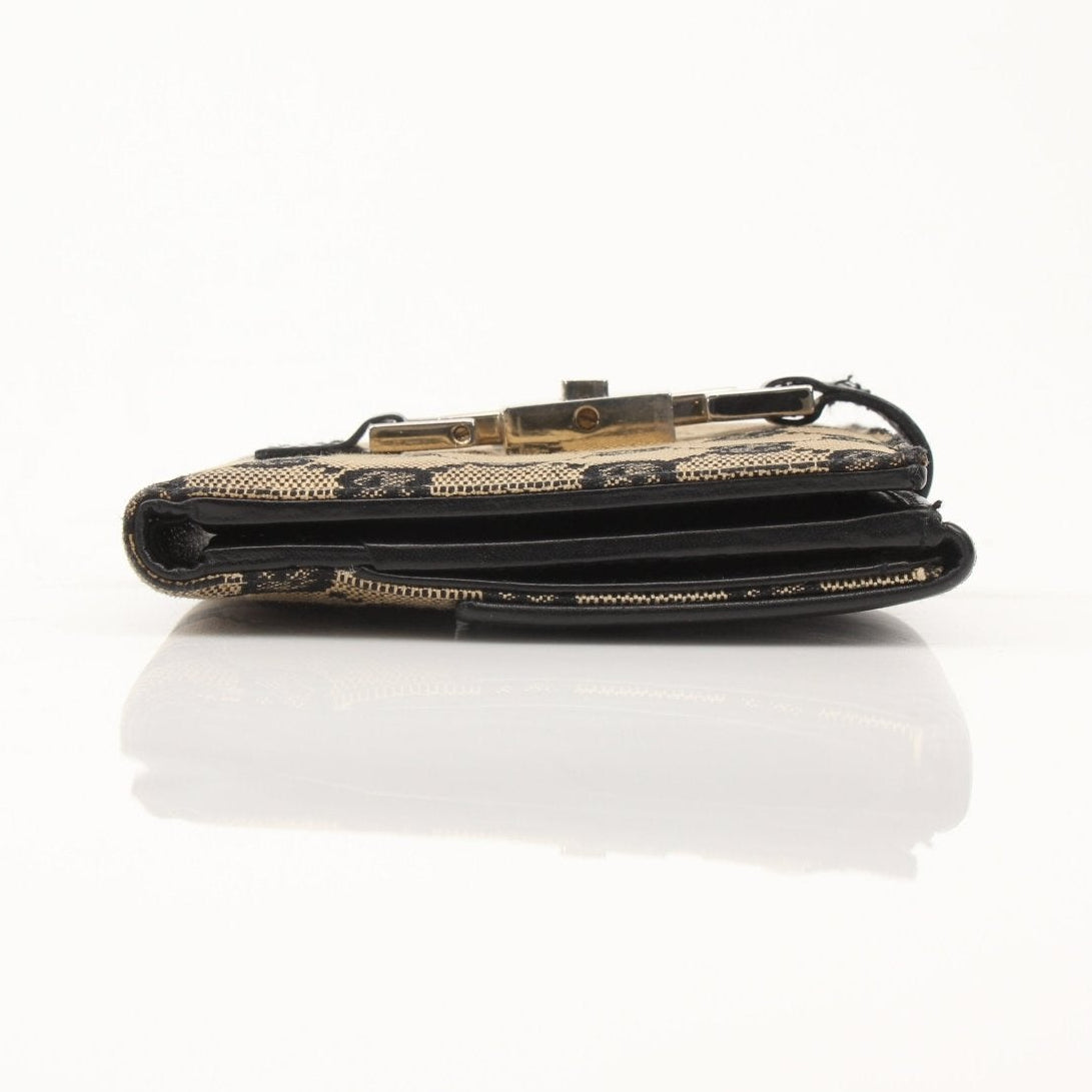 Vintage Gucci Jackie GG wallet by Gold & Beyond featuring the iconic monogram canvas and gold-tone hardware.