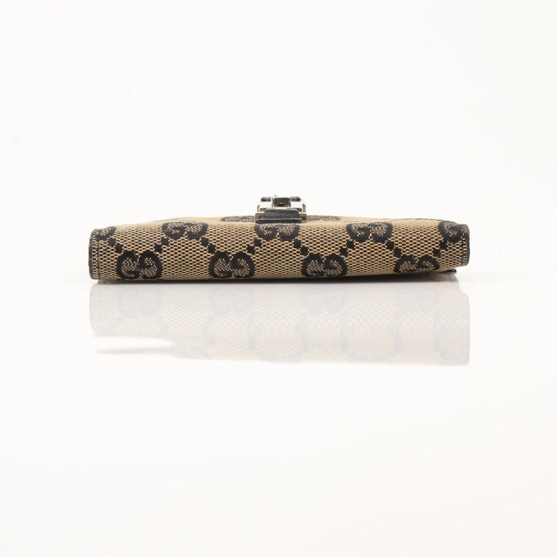 Vintage Gucci Jackie GG wallet by Gold & Beyond showing the classic monogram pattern and leather details.
