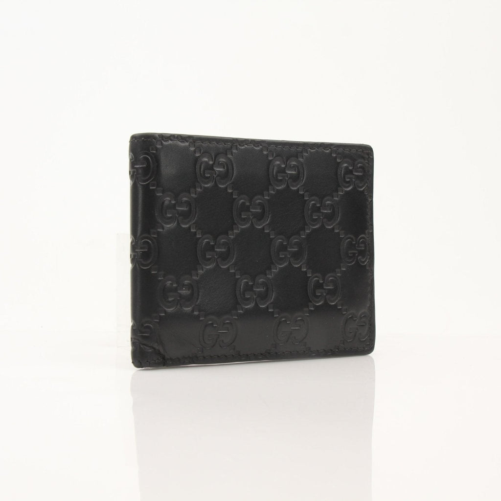 Gold & Beyond Gucci Guccissima bi-fold wallet with textured leather, multiple card slots, and sleek design visible in the image.