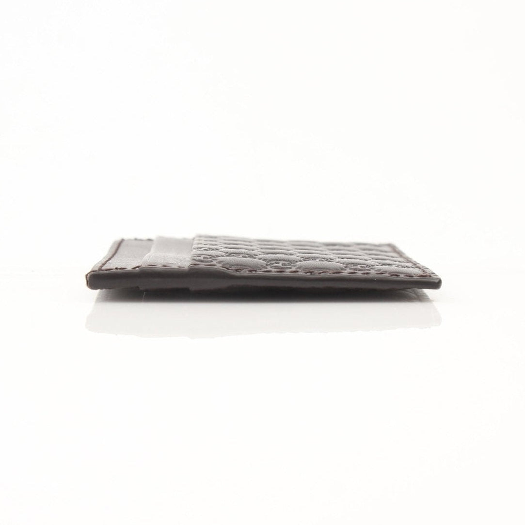 Gold & Beyond Gucci Guccissima leather cardholder wallet with embossed logo and multiple card slots on a white background.