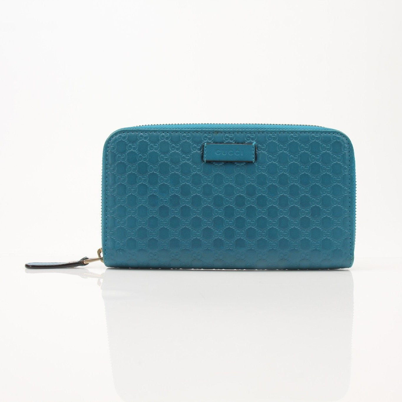 Gold & Beyond Gucci MicroGuccissima wallet with leather finish, compact design featuring multiple card slots and embossed logo.