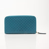 Gucci Micro Guccissima wallet with gold accents, featuring signature monogram pattern and compact leather design.