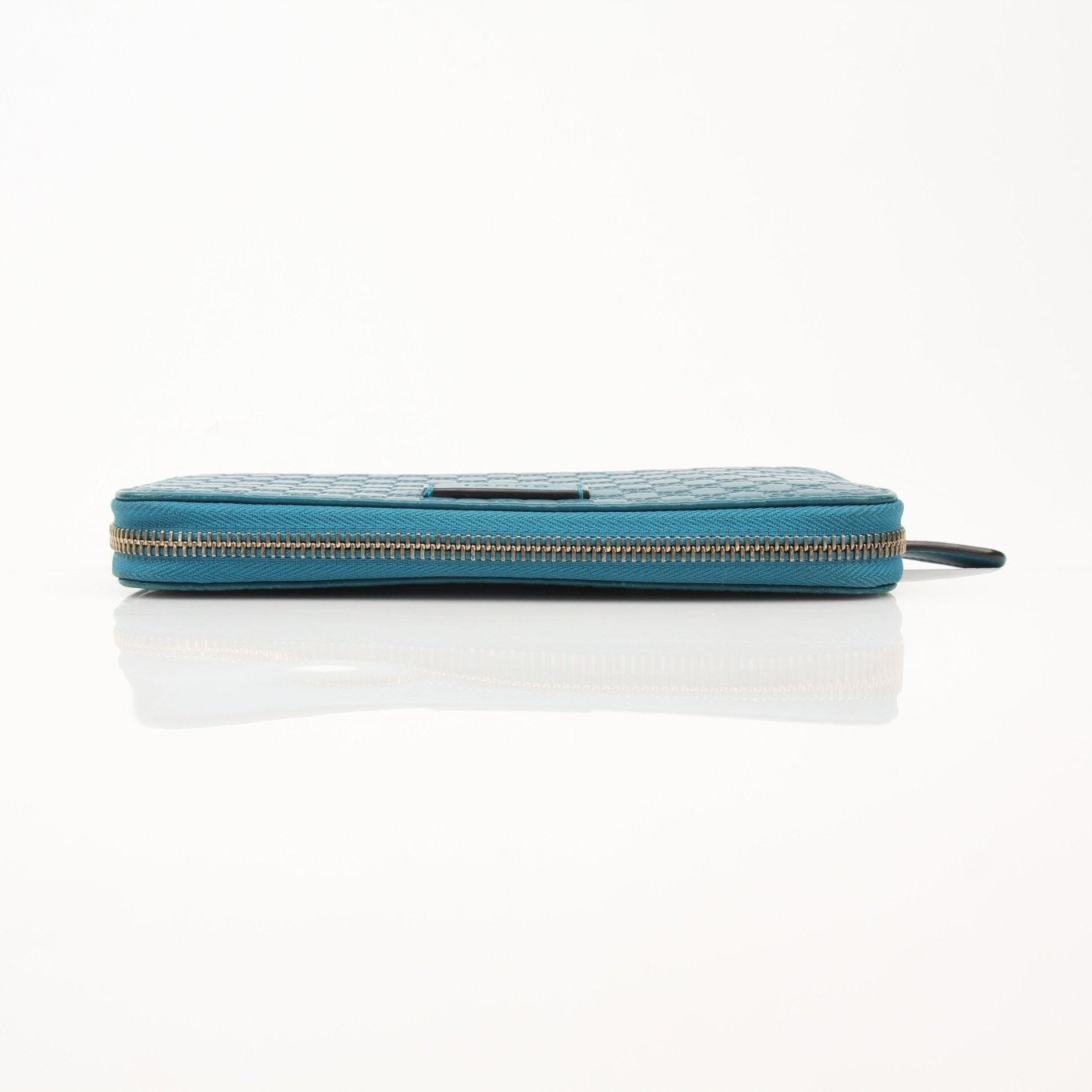 Gold & Beyond Gucci Micro Guccissima wallet showing textured leather exterior and compact design.