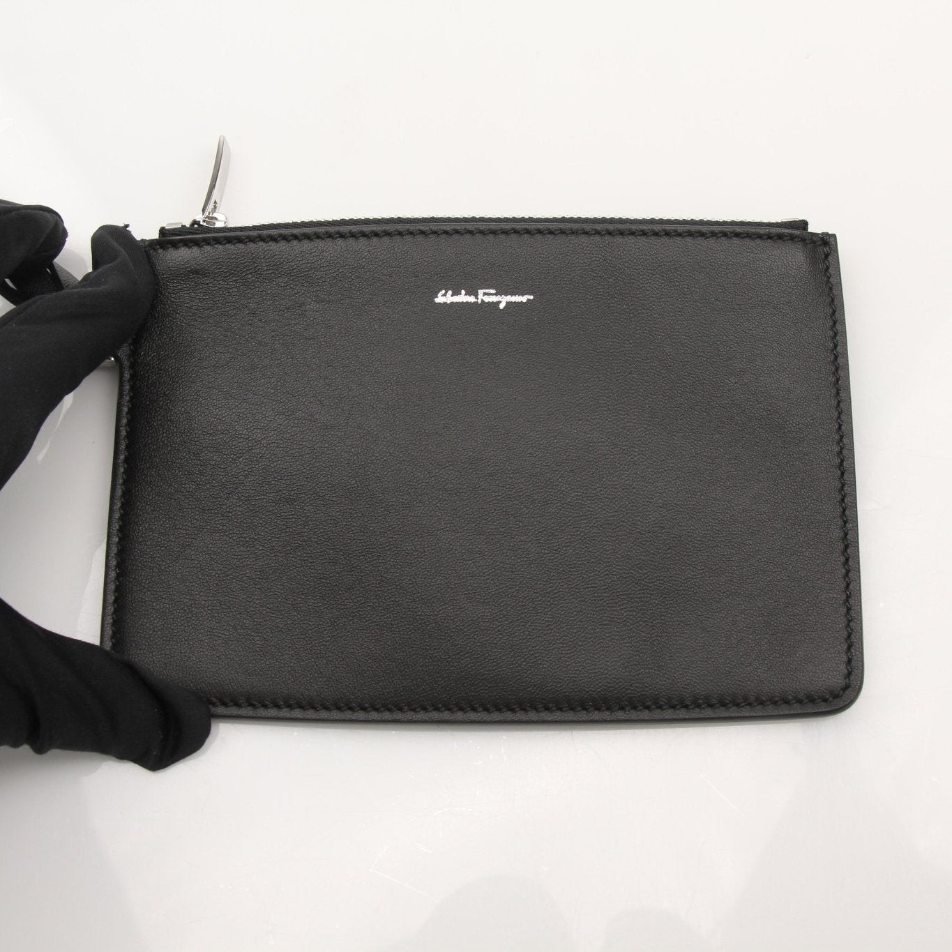 Salvatore Ferragamo stone crocodile bucket handbag with textured finish and adjustable strap, displayed on a neutral background.