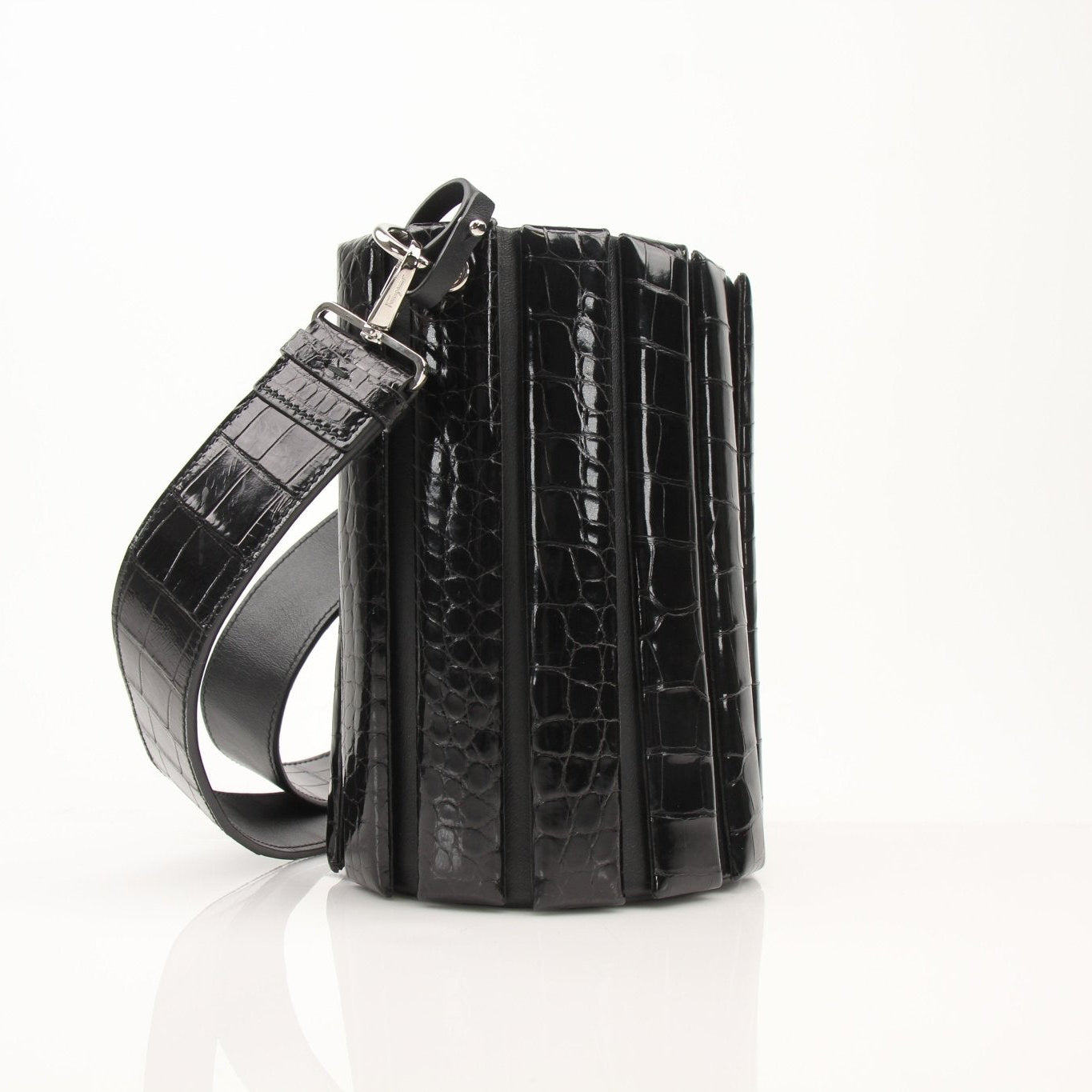 Salvatore Ferragamo stone crocodile bucket handbag with textured leather and a stylish silhouette.