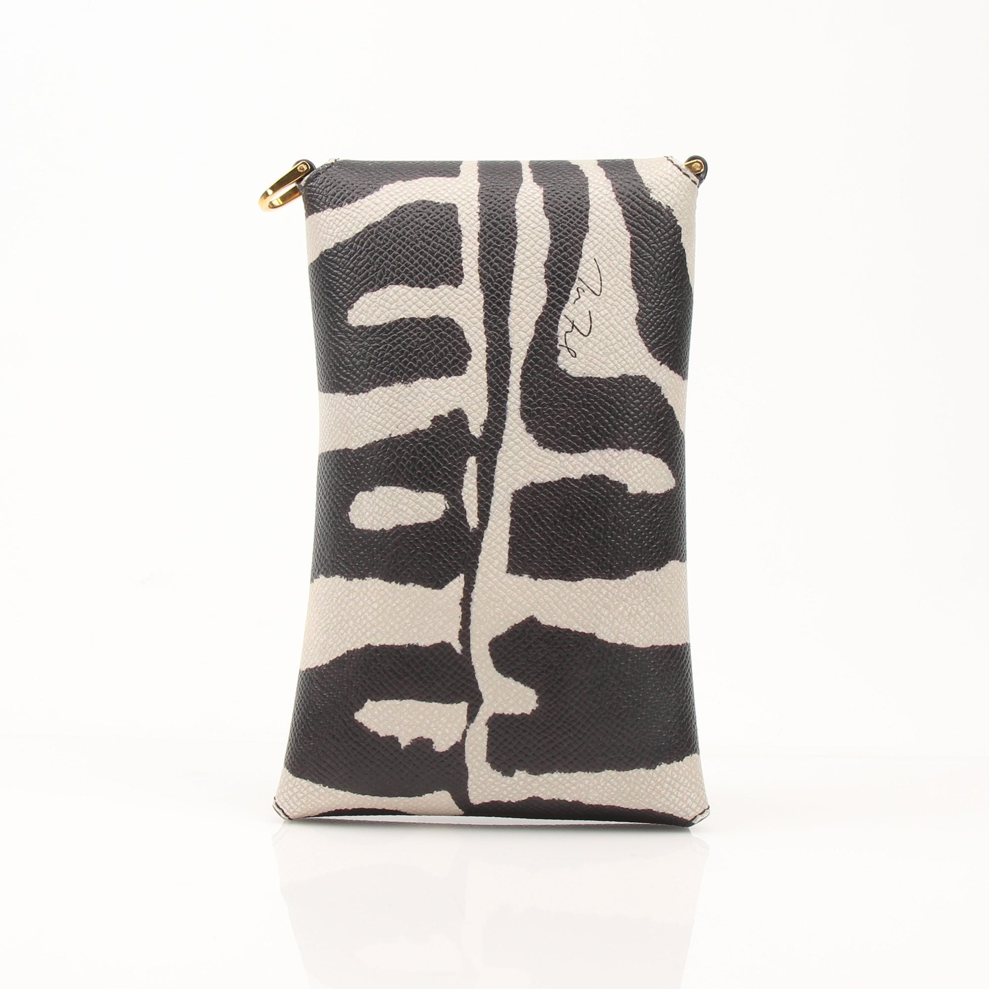 Gold & Beyond Tom Ford cell phone case accessory with sleek design, shown on a smartphone in the image.