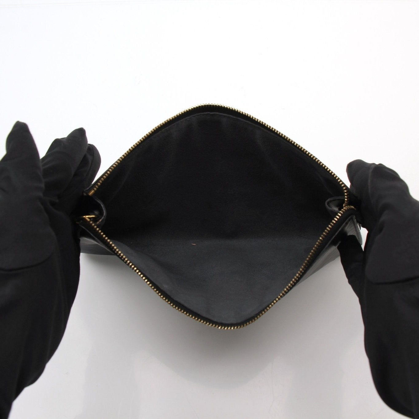 Louis Vuitton Pochette handbag in gold with leather accents, featuring a compact design and stylish hardware.