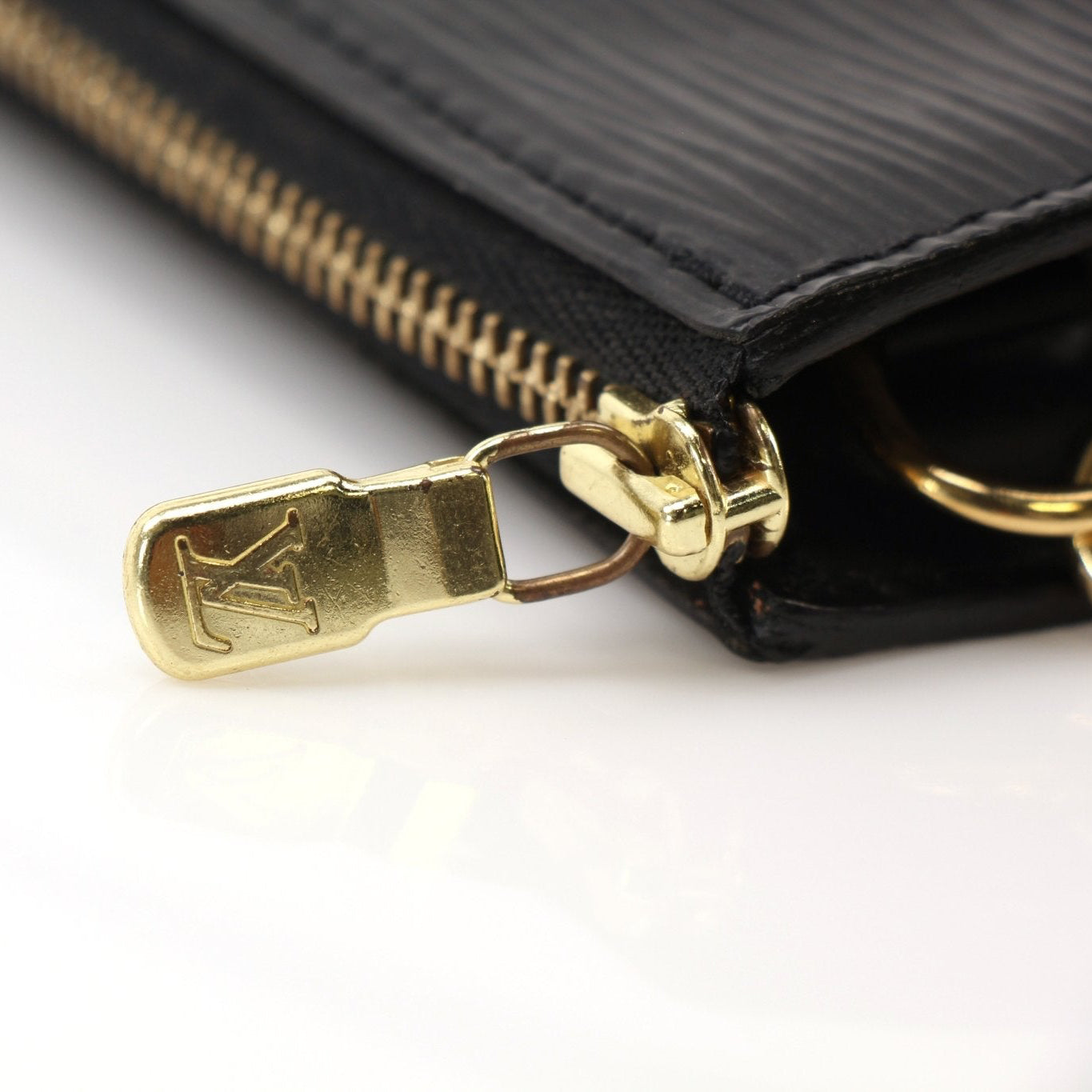Gold & Beyond Louis Vuitton Pochette handbag with gold-tone hardware and monogram canvas, showing front view with strap detail.