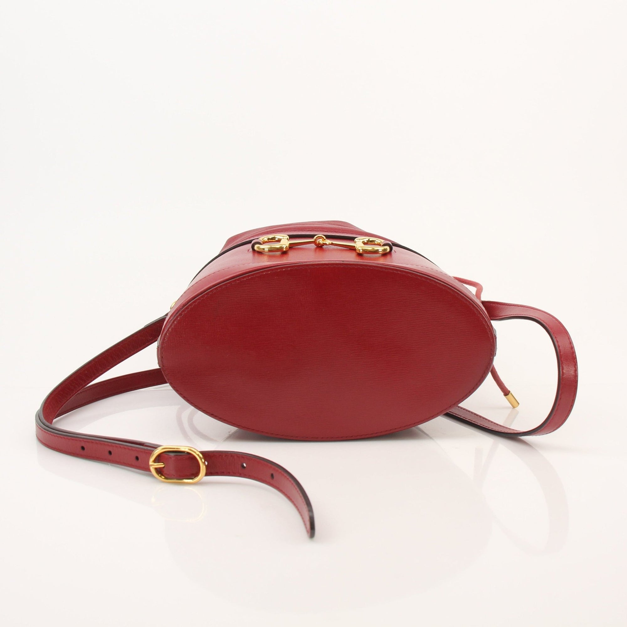 Gold & Beyond Gucci 1955 Horsebit Bucket Bag handbag with gold-tone hardware and stylish design, displayed on a plain background.