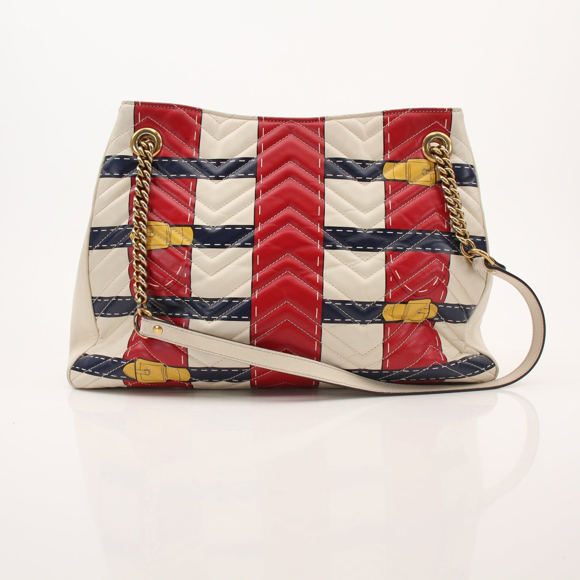 Gold & Beyond Gucci Trompe L’oeil GG shoulder handbag with structured design and top handle, featuring distinctive logo pattern.