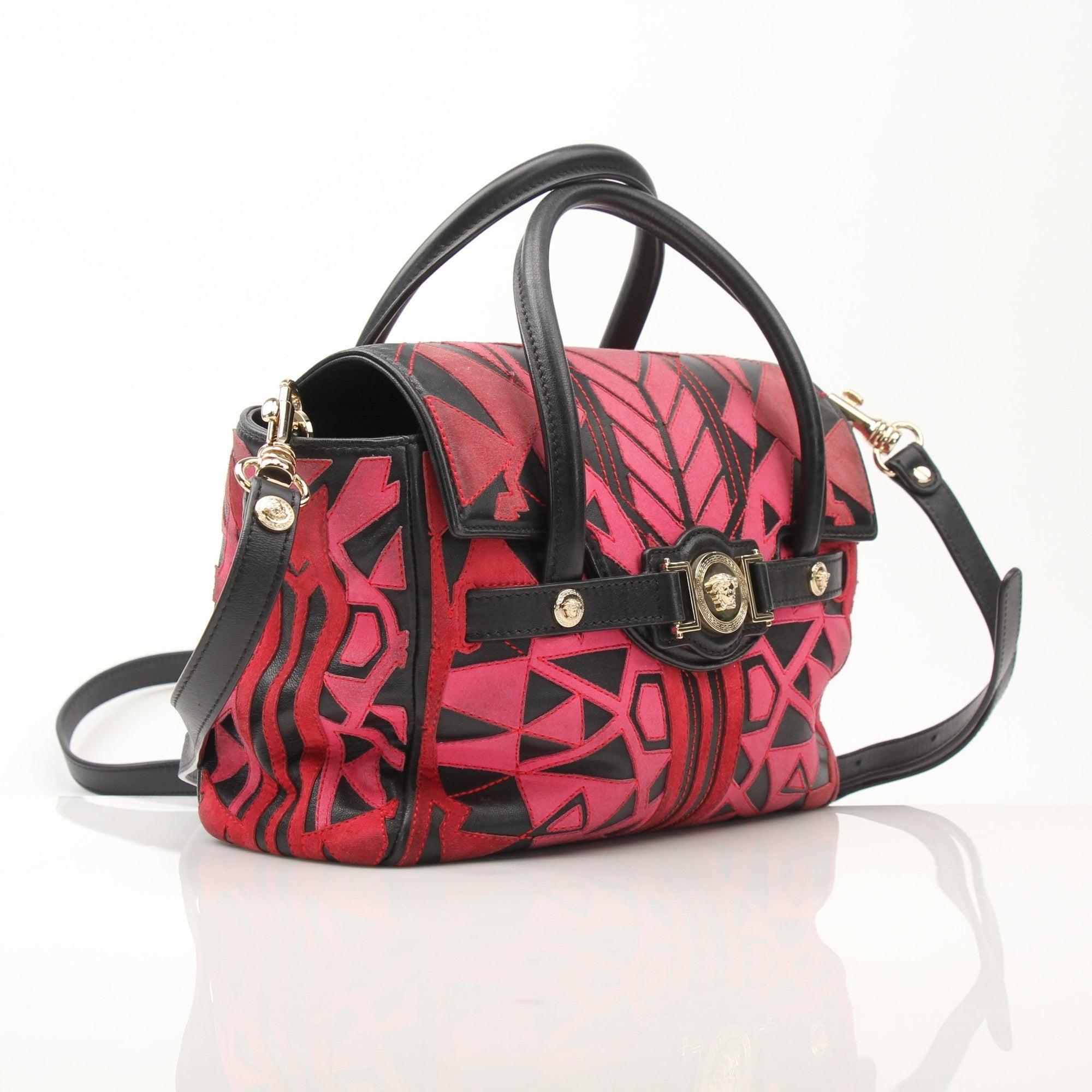Gold & Beyond Versace patchwork crossbody handbag with colorful design and adjustable strap, made of leather and fabric.