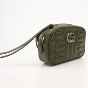 Gold & Beyond Gucci GG camera handbag with leather accents and gold hardware, stylish and compact for everyday use.