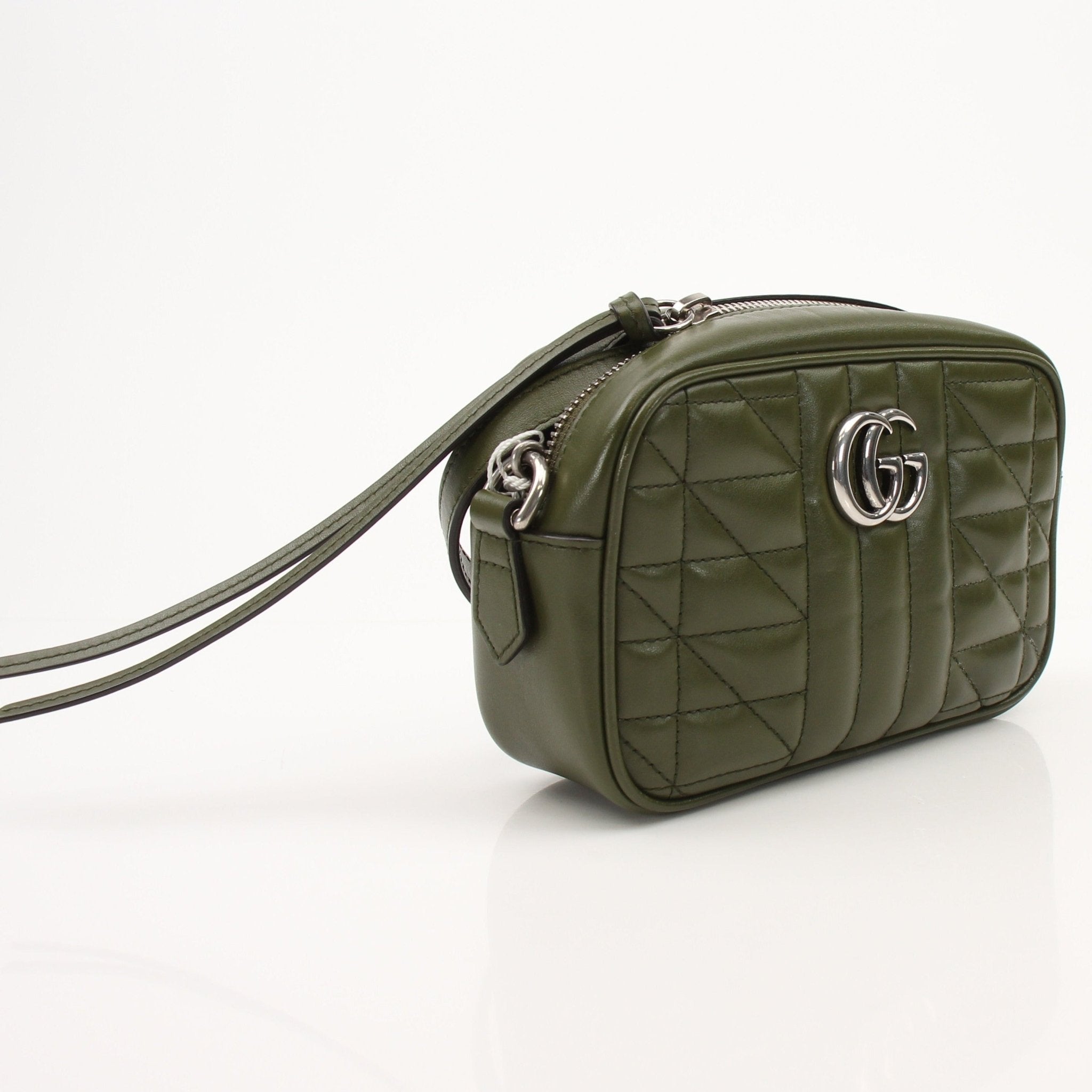Gold & Beyond Gucci GG camera handbag with leather accents and gold hardware, stylish and compact for everyday use.