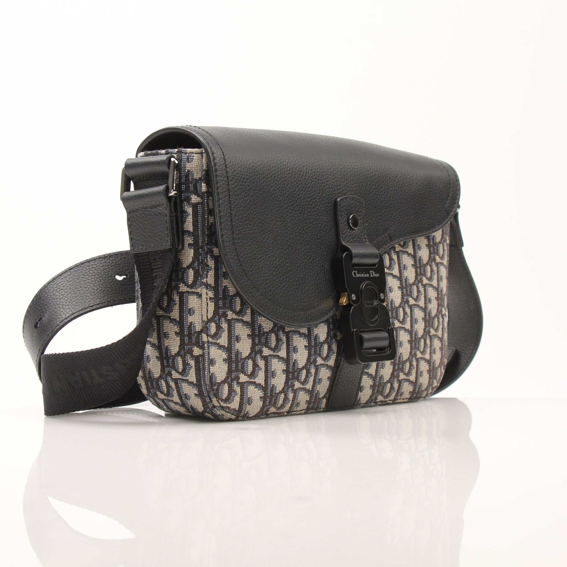 Gold & Beyond Dior Saddle Messenger handbag with adjustable strap and signature design, displayed on a neutral background.