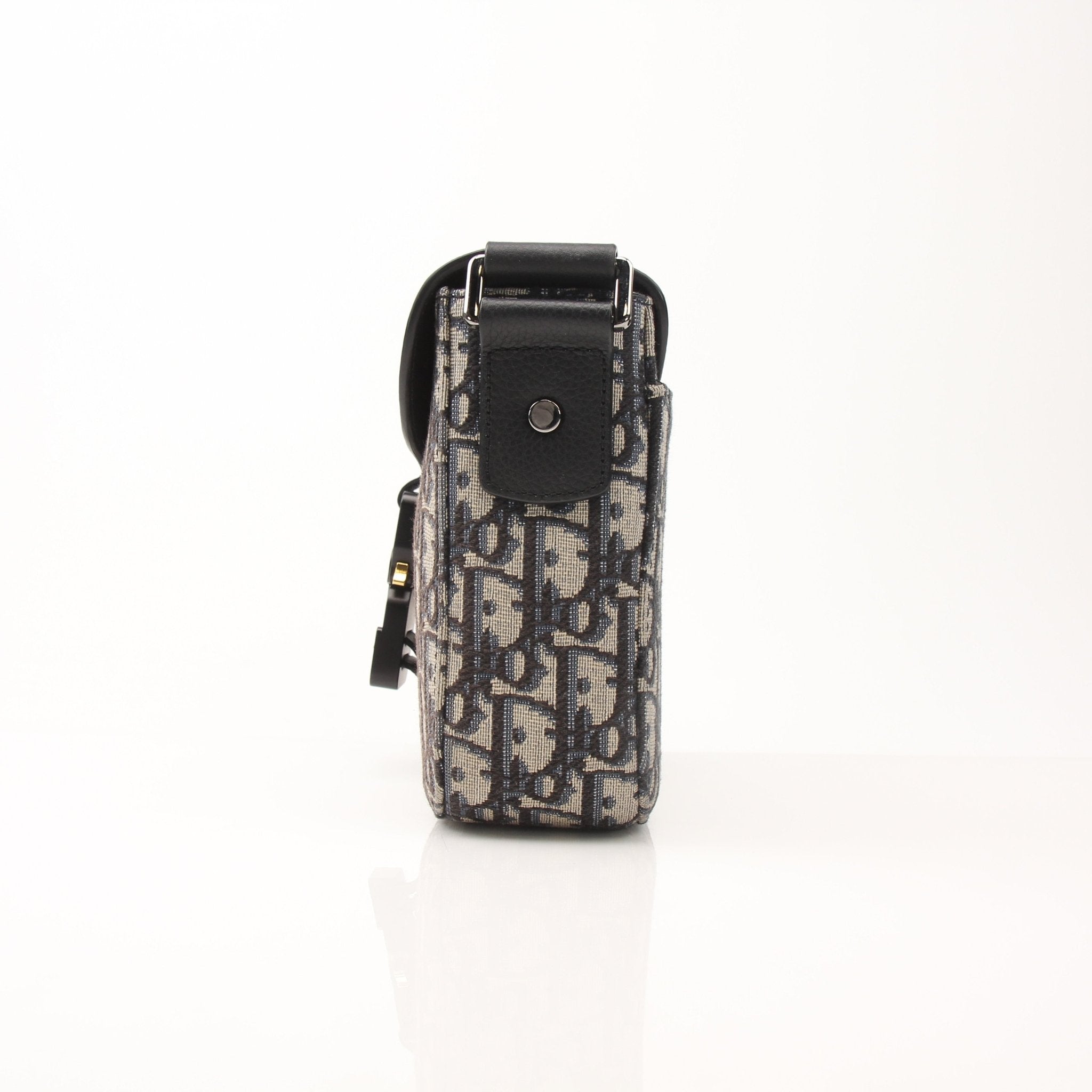 Gold & Beyond Dior Saddle Messenger handbag with adjustable strap and signature saddle design, crafted in luxurious material.