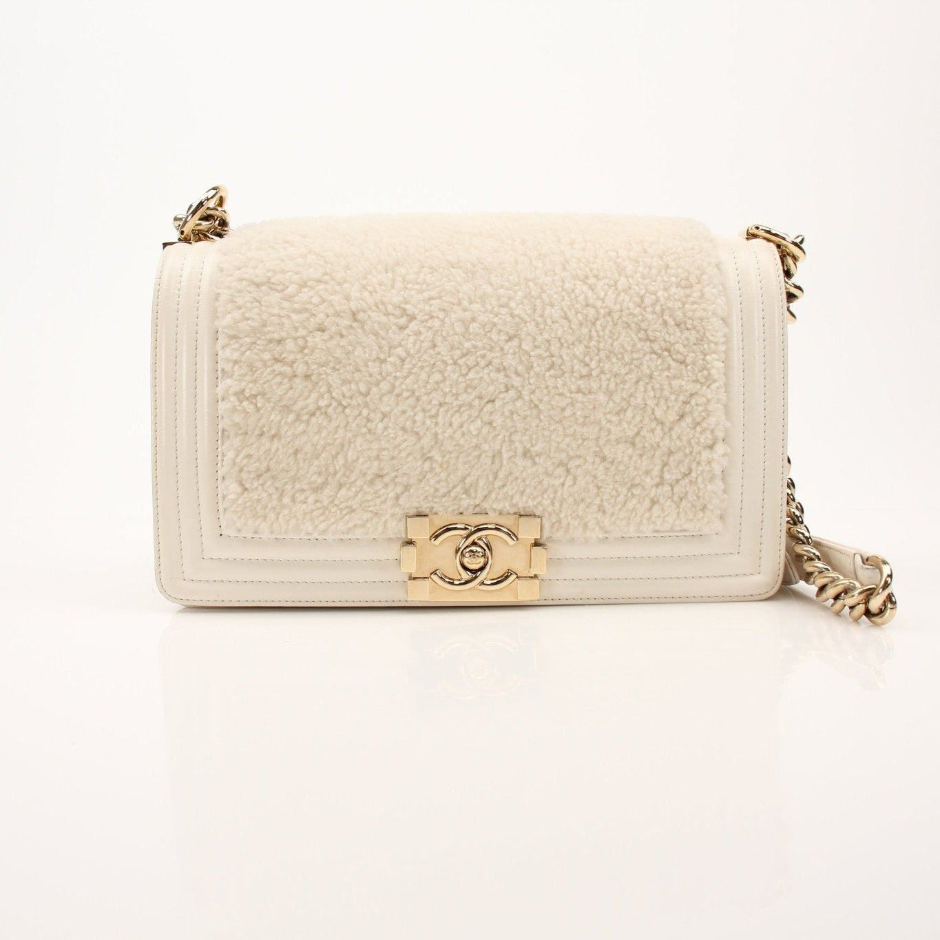 Gold & Beyond Chanel Le Boy shoulder handbag with structured design and gold-tone hardware, featuring a chain strap and quilted leather.