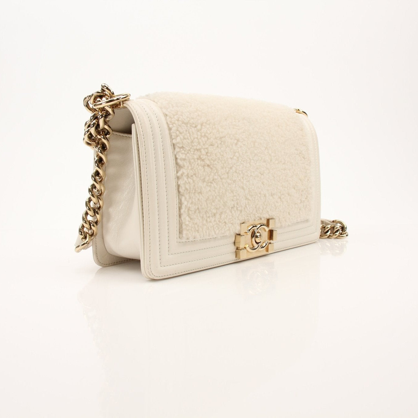 Gold & Beyond Chanel Le Boy shoulder handbag with quilted leather and gold-tone hardware, stylish and luxurious accessory.