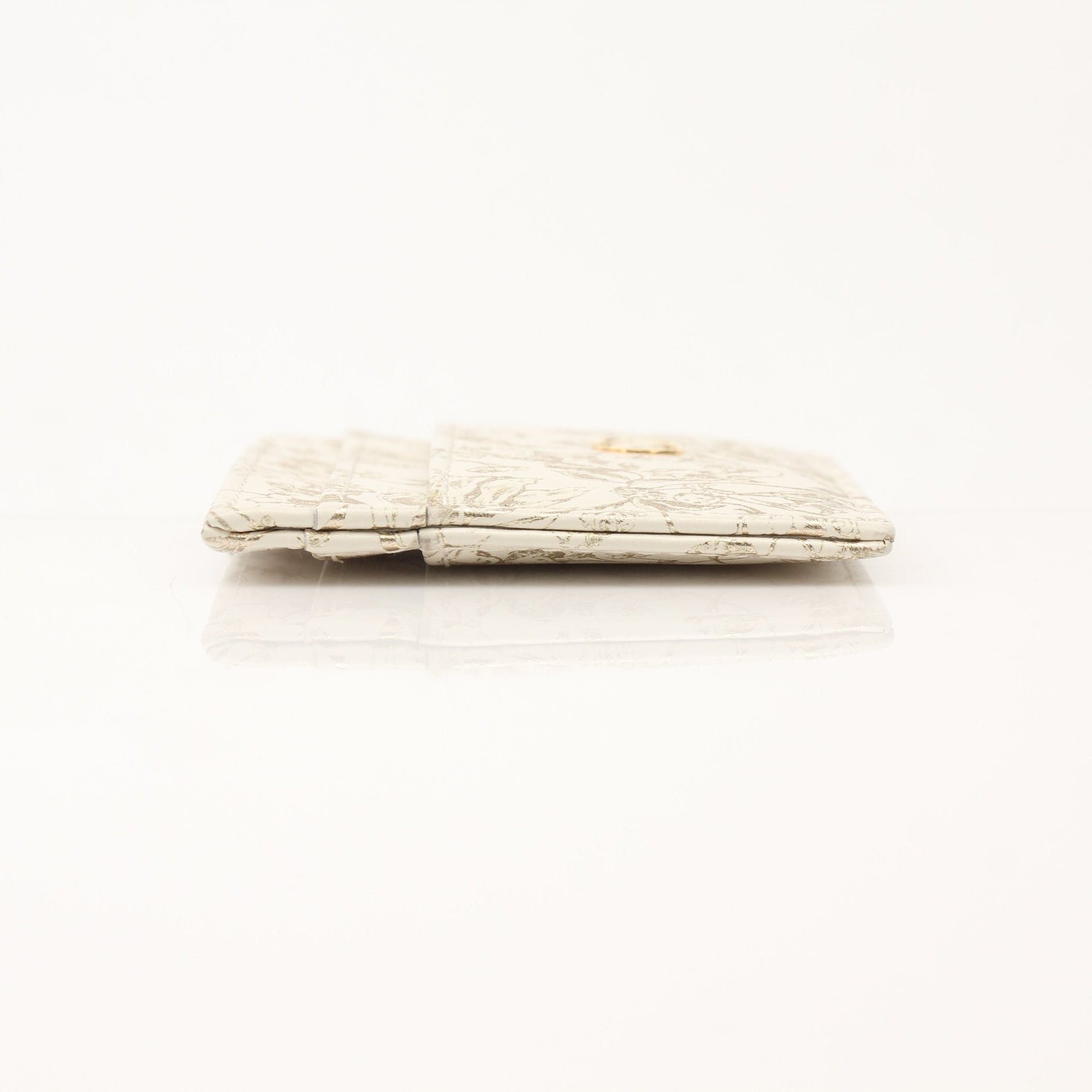 Christian Dior Caro Freesia cardholder wallet with gold accents, featuring a sleek design and floral pattern.