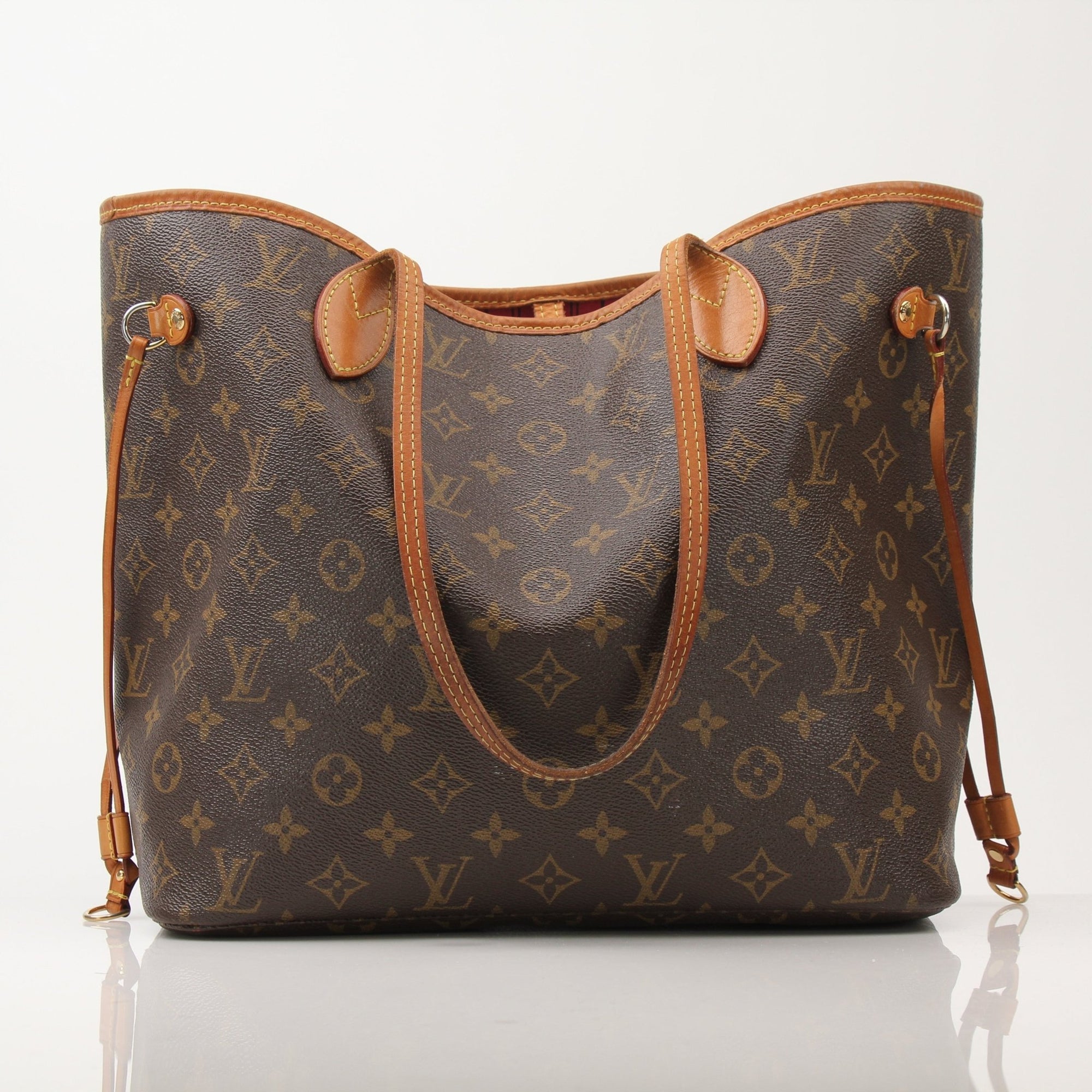 Louis Vuitton Neverfull Monogram Tote handbag with gold accents and adjustable straps, featuring iconic LV monogram canvas.