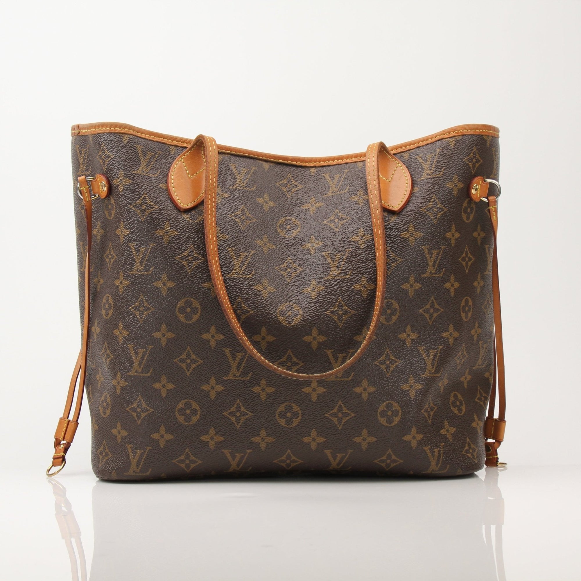 Louis Vuitton Neverfull Monogram tote handbag with leather trim and spacious interior, showcased in a stylish gold and beige design.