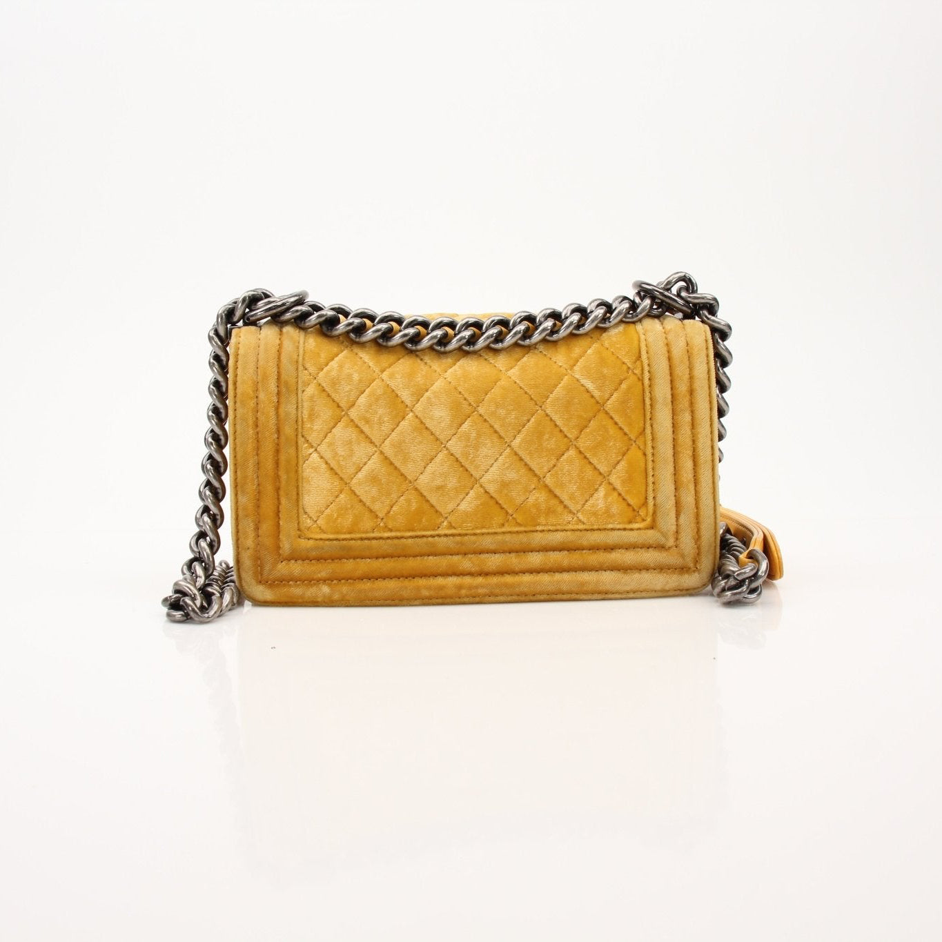Chanel Small Le Boy Bag in mustard yellow velvet and leather, showcasing its luxurious design and gold-tone hardware.