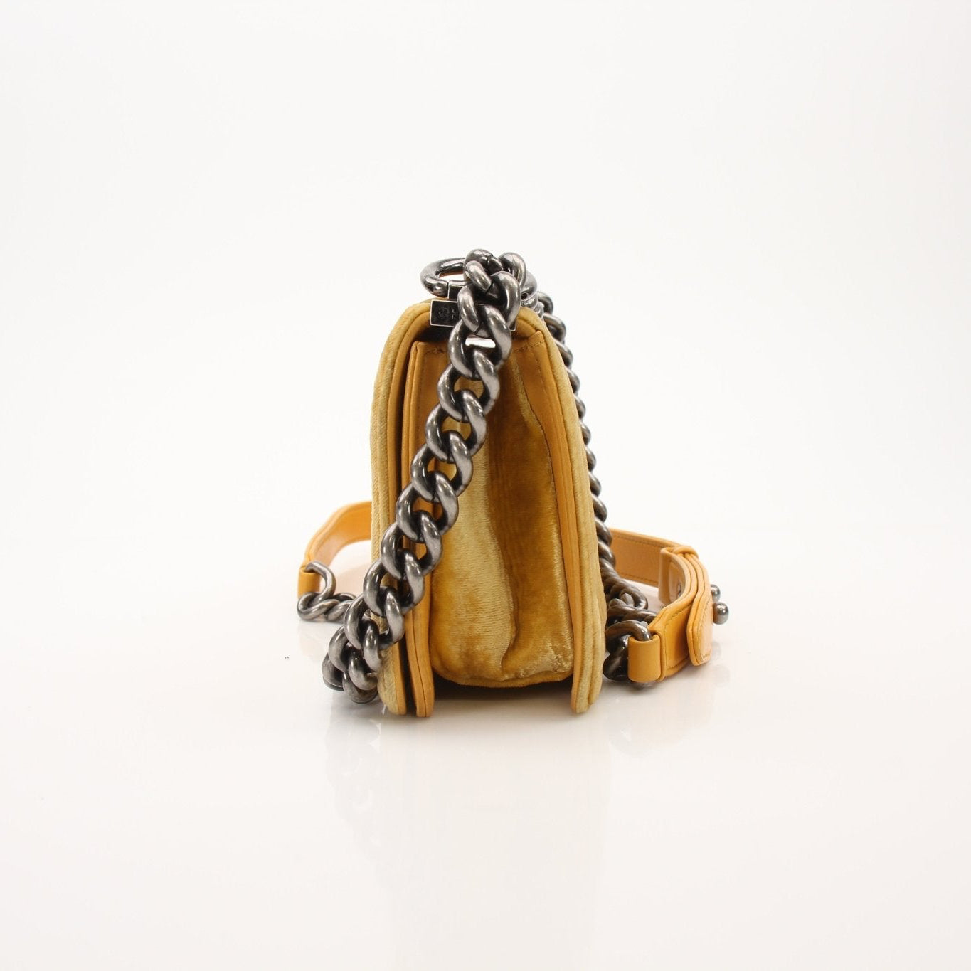 Chanel Small Le Boy Bag in mustard yellow velvet and leather, showcasing its luxurious texture and stylish design.