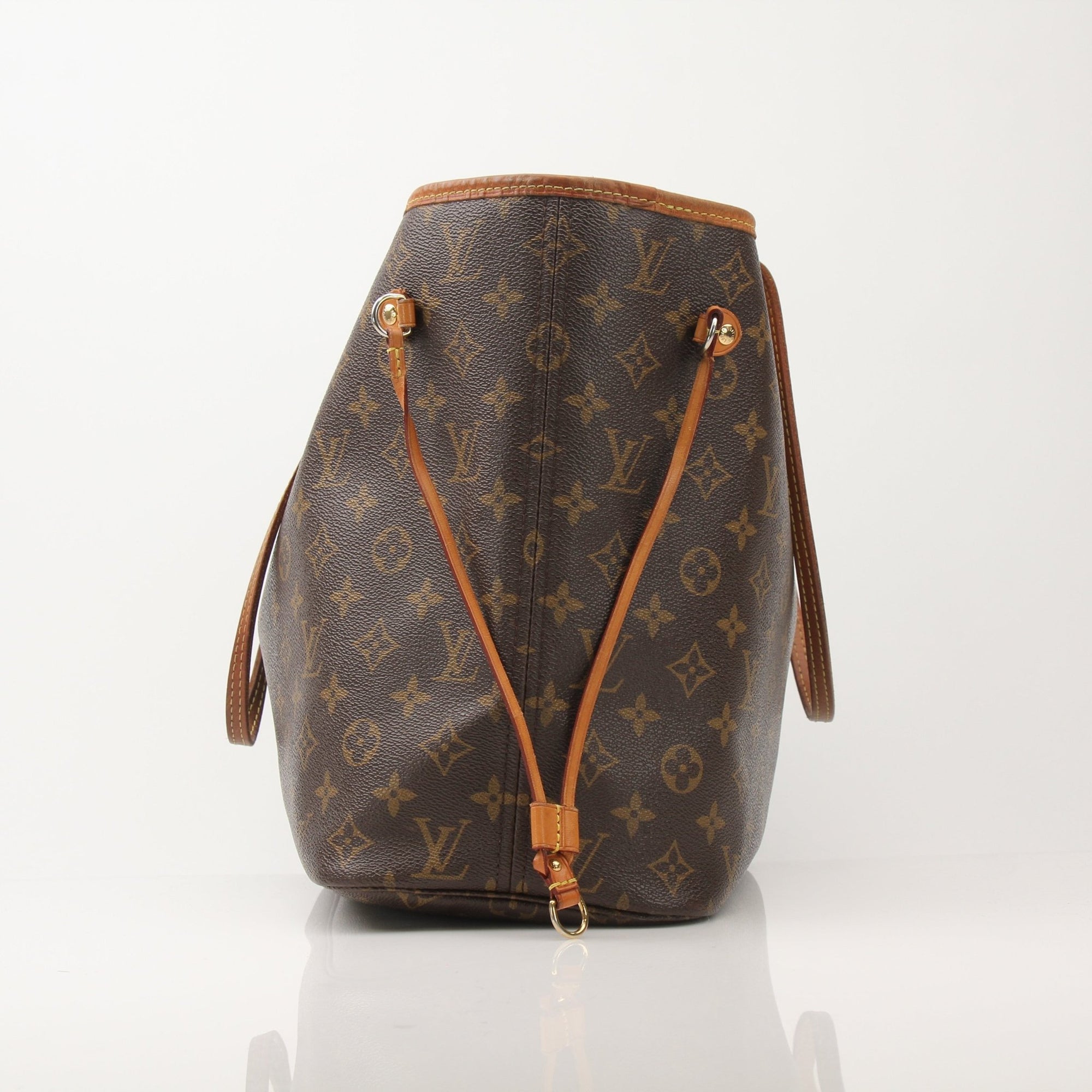 Louis Vuitton Neverfull Monogram tote handbag with brown leather trim and gold-tone hardware, displayed on a neutral background.