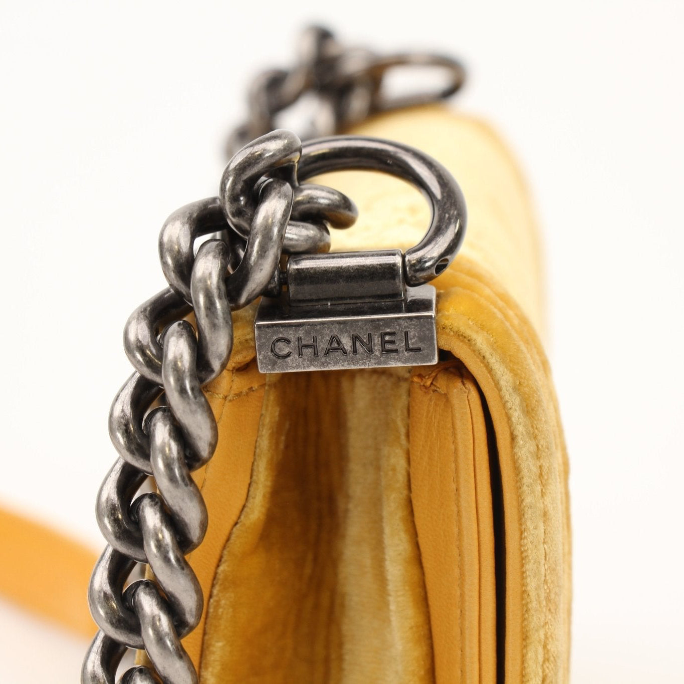 Chanel Small Le Boy Bag in mustard yellow velvet and leather, featuring gold-tone hardware and adjustable strap.
