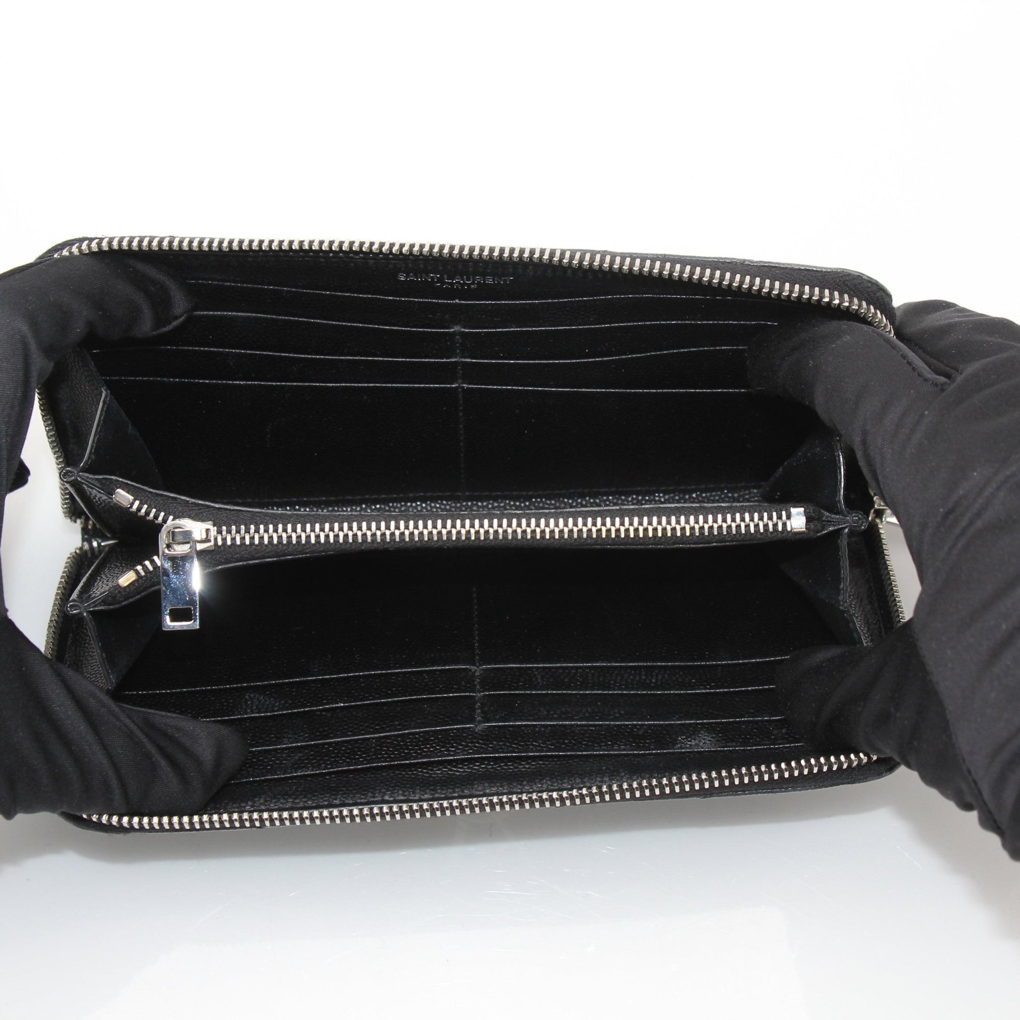 Yves Saint Laurent Chevron Wallet in black leather with signature chevron pattern and gold-tone hardware.