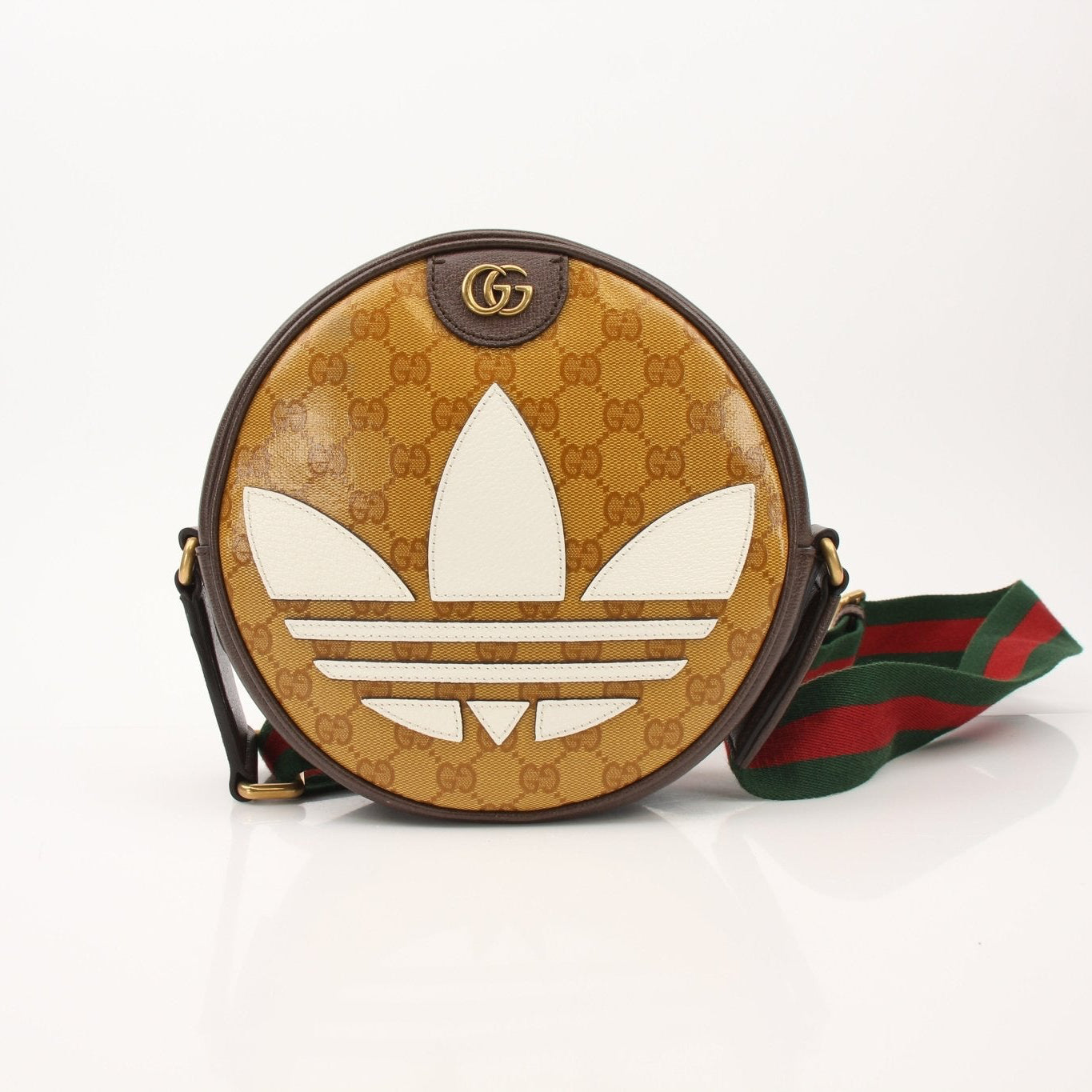 Gold & Beyond Gucci x Adidas round shoulder handbag with beige and black design, featuring logo accents and a compact, stylish shape.