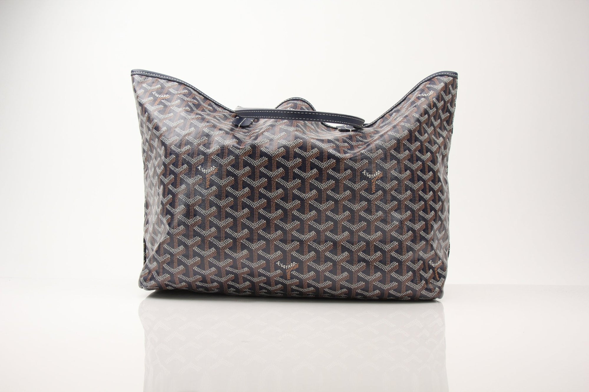 Goyard Saint Louis PM tote handbag with beige canvas and brown leather handles, featuring classic Goyard pattern and gold accents.