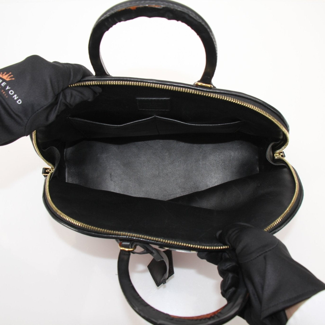 Gold & Beyond Louis Vuitton Alma PM satchel handbag with leather handles and classic monogram canvas.