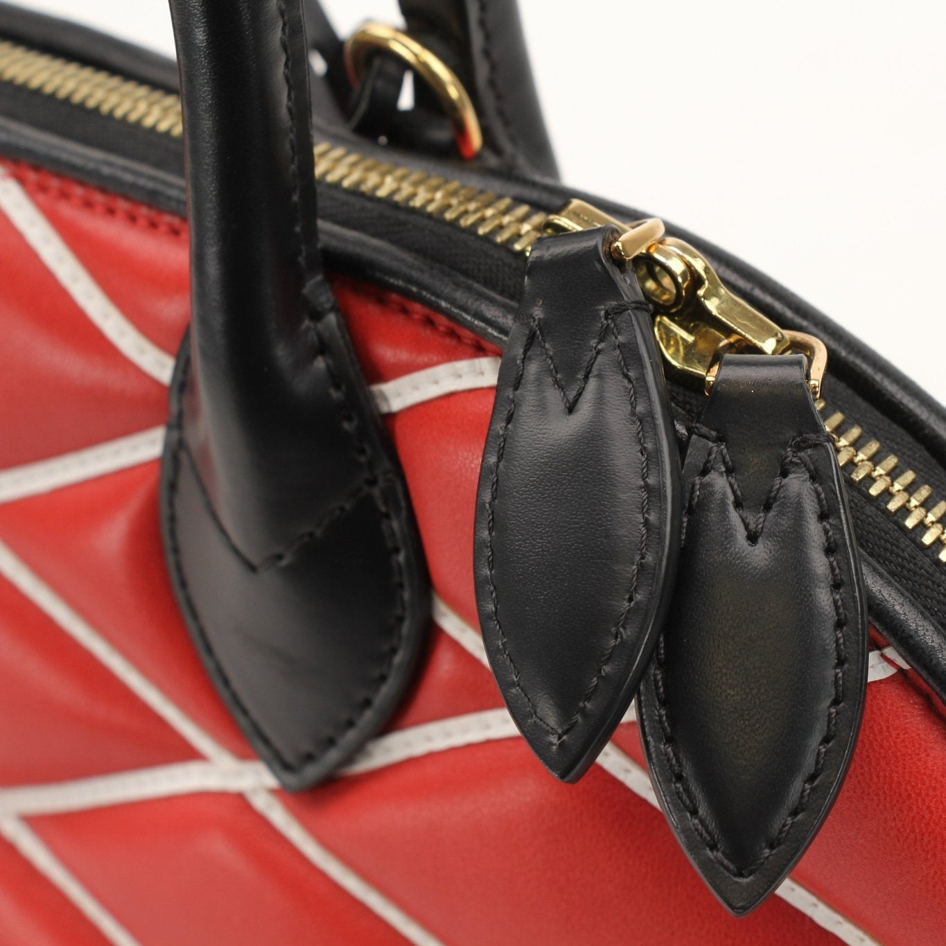 Louis Vuitton Alma PM Satchel Bag in brown leather with gold-tone hardware, shown in a close-up view of the handbag.