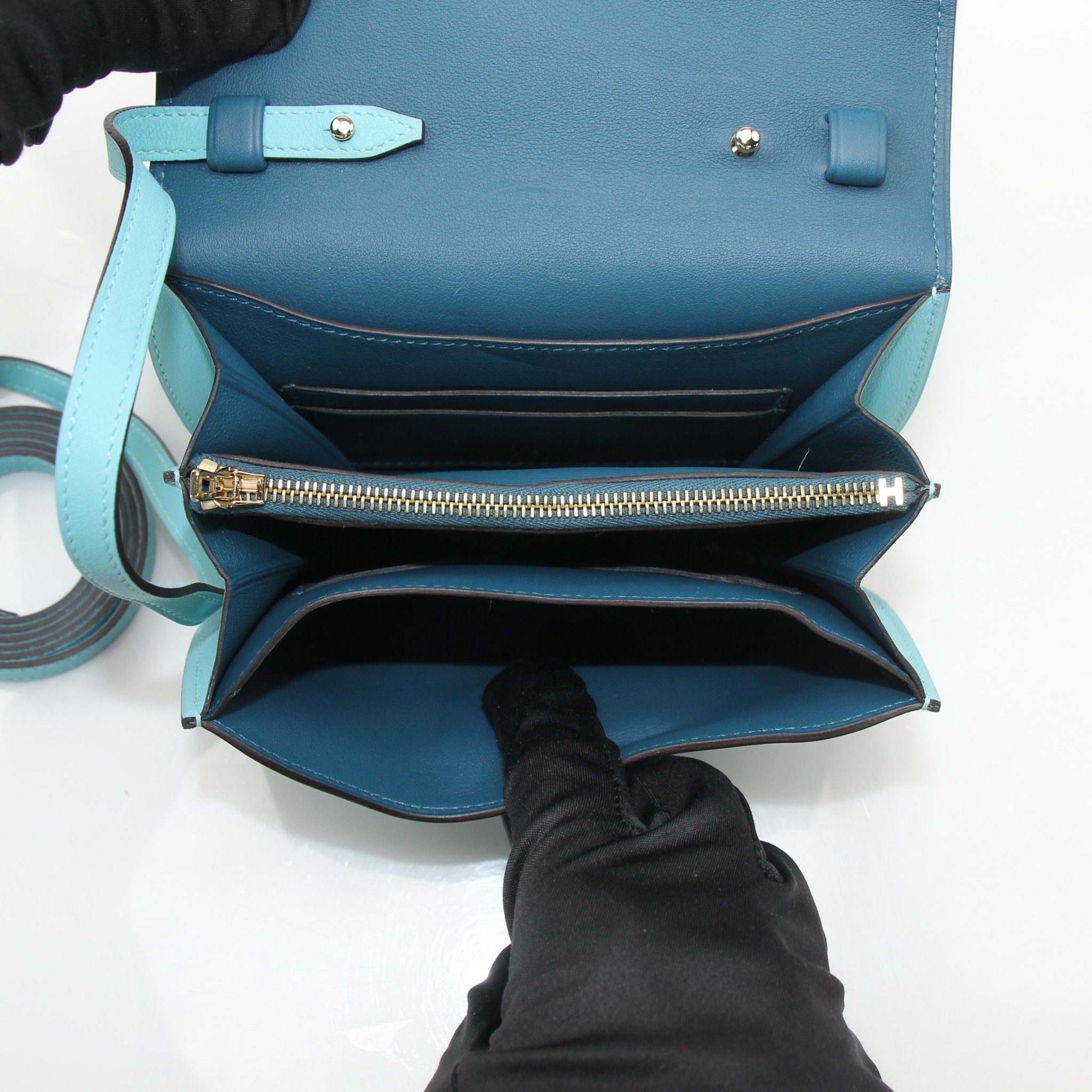 Hermès Convoyeur handbag by Gold & Beyond, featuring smooth leather and gold-tone hardware, shown in a stylish close-up image.