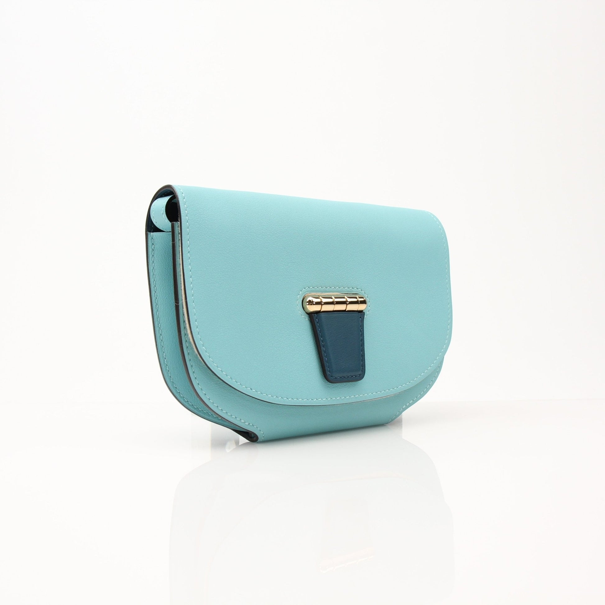 Gold & Beyond Hermès Convoyeur handbag with sleek leather design and gold hardware, displayed on a neutral background.