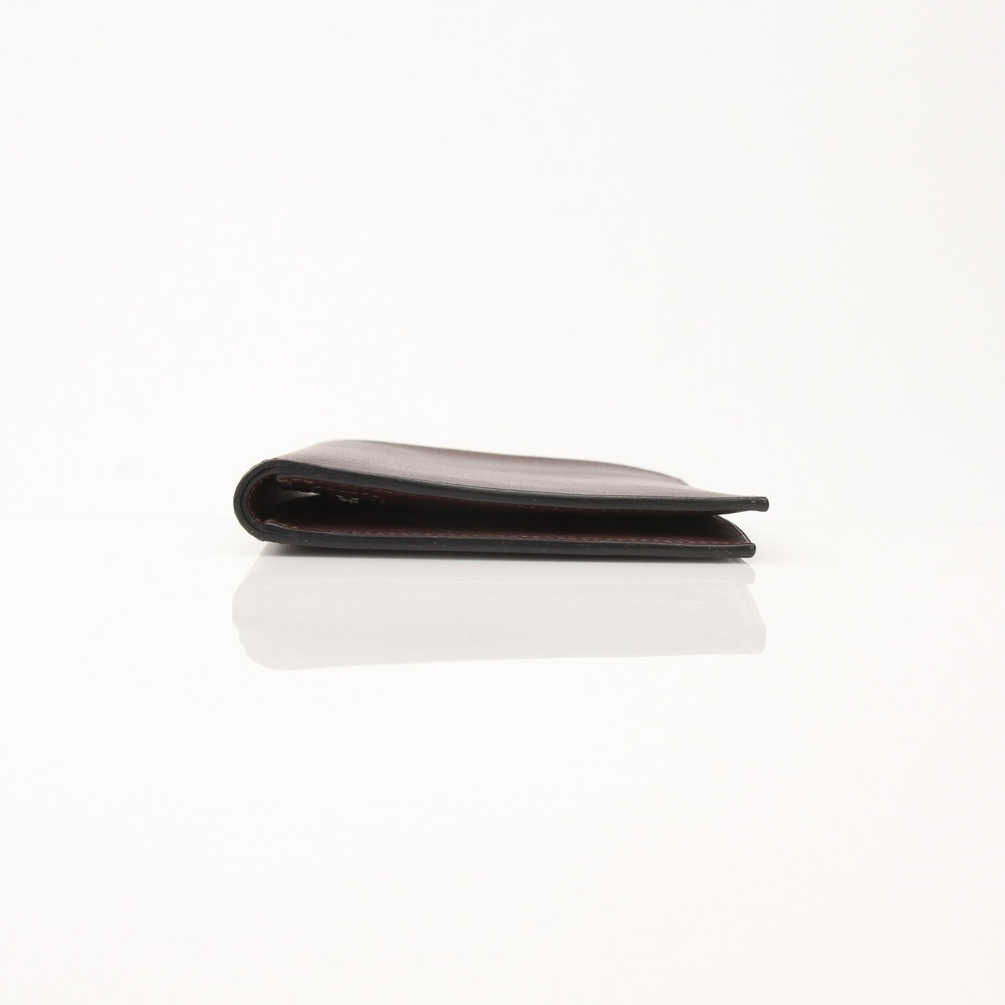 Hermès leather wallet by Gold & Beyond, showcasing sleek design and high-quality craftsmanship, in a close-up view.