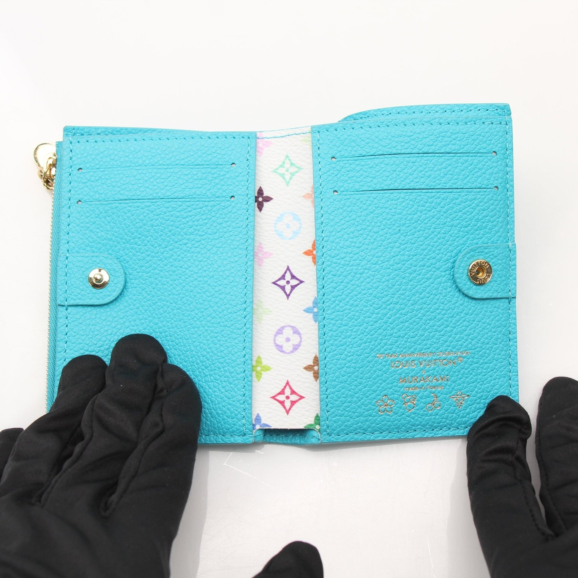Louis Vuitton x Takashi Murakami compact wallet by Gold & Beyond, featuring colorful floral design and gold accents.