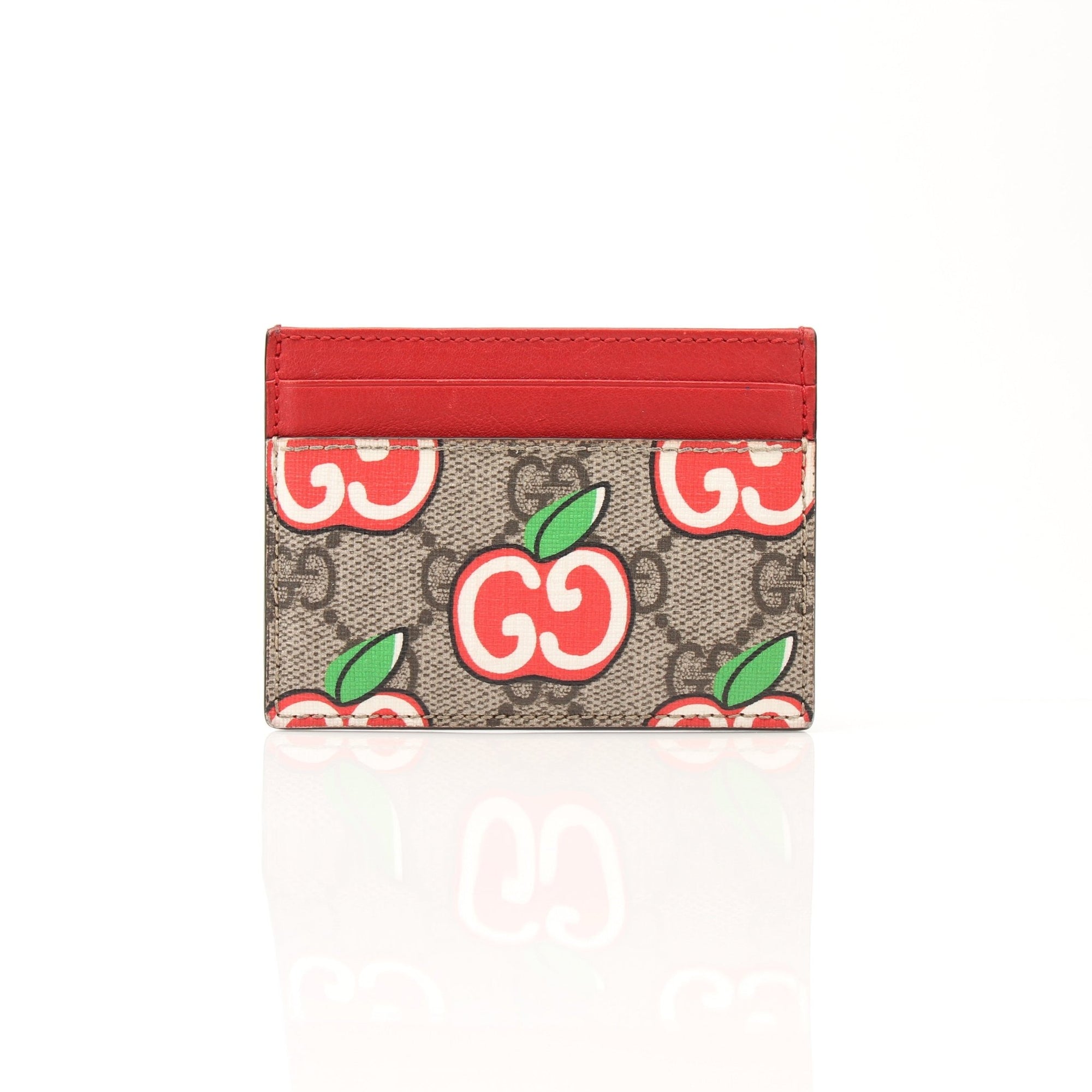 Gucci GG Supreme leather Apple Cardholder with gold accents, slim compact design, and branded logo for stylish everyday use.