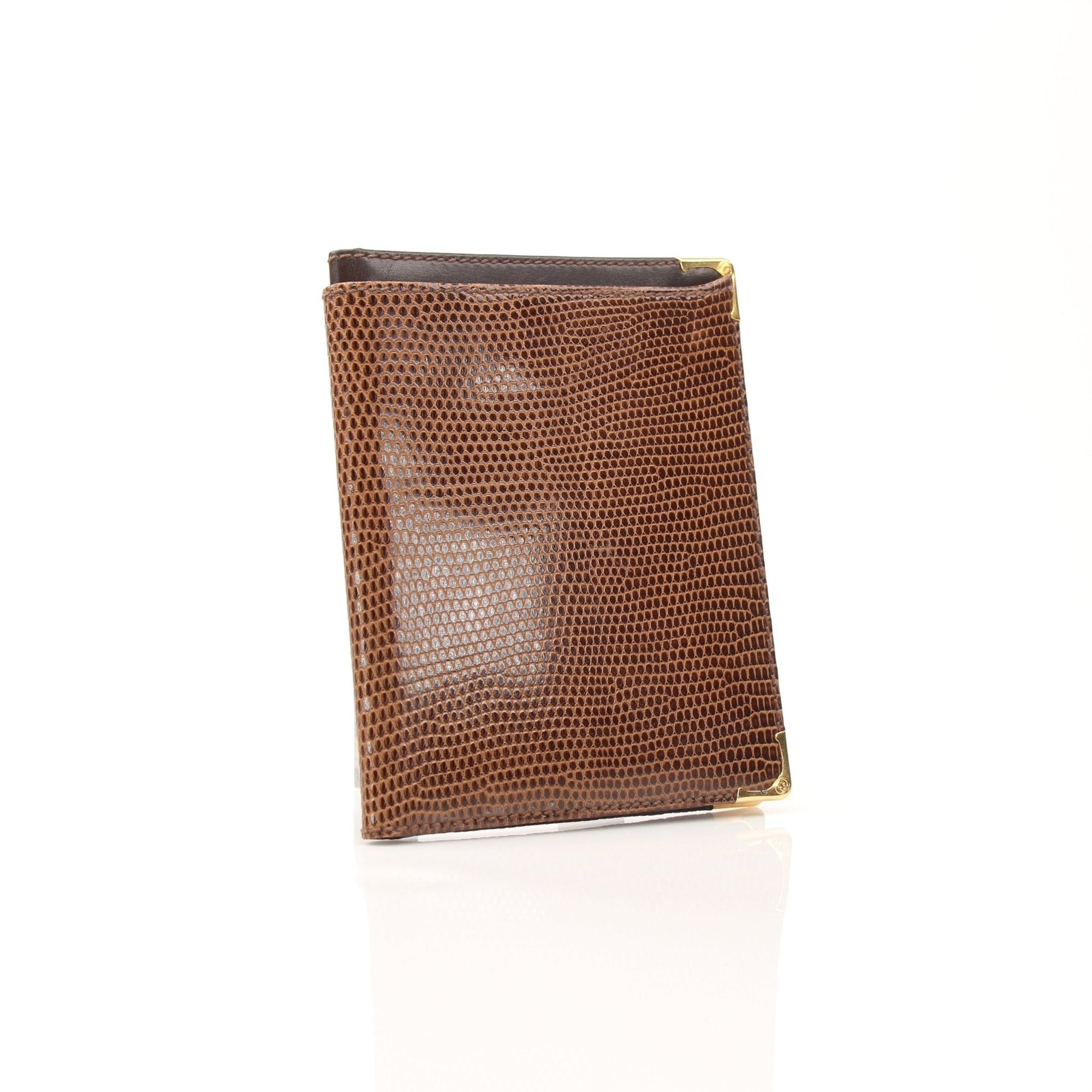 Gucci vintage lizard embossed leather wallet with gold accents, compact design, and stitched edges, showcasing luxury craftsmanship.