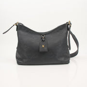 Louis Vuitton Carryall PM handbag with gold hardware and leather accents, shown in a sleek, structured design.