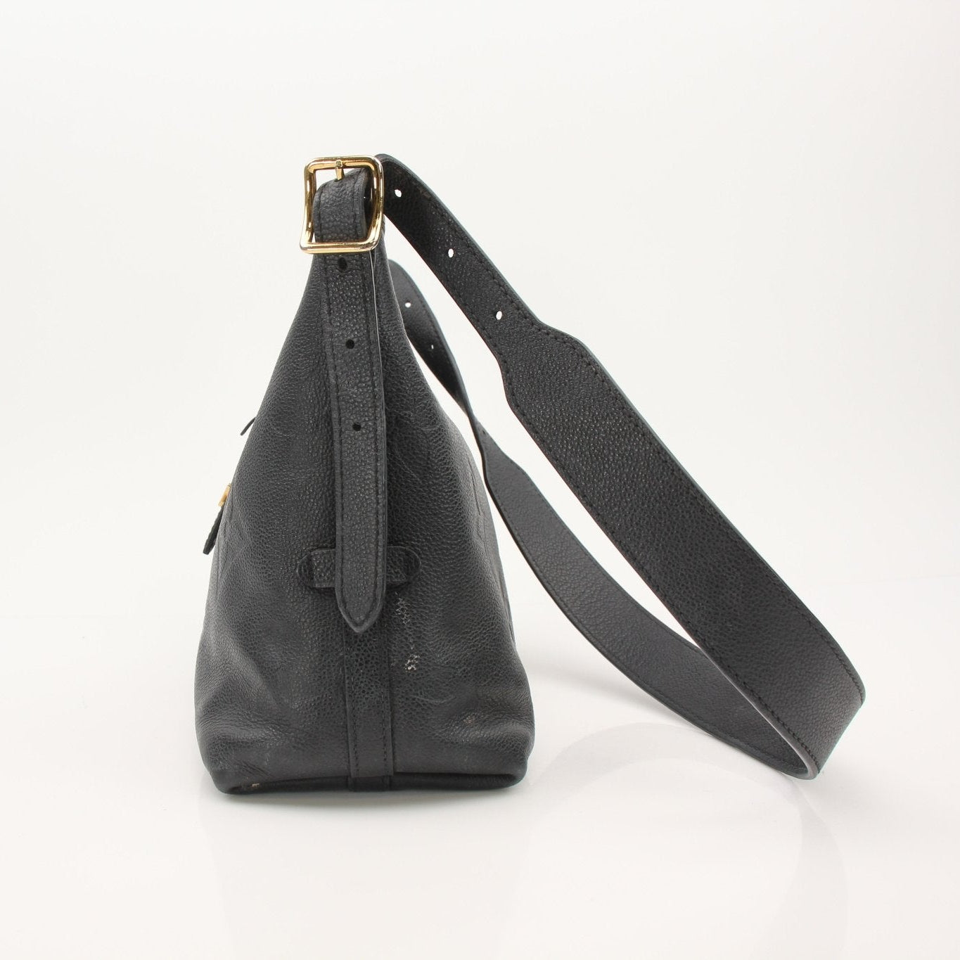 Louis Vuitton Carryall PM handbag with gold-toned hardware and monogram canvas, shown in a close-up view of the bag's front.