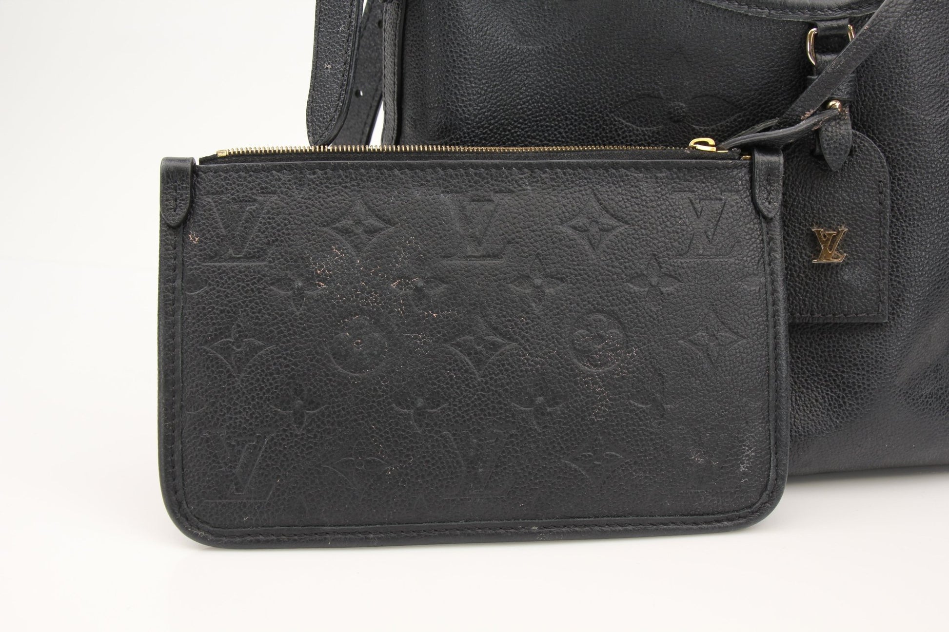Gold & Beyond Louis Vuitton Carryall PM handbag with leather handles and monogram canvas, displayed on a neutral background.
