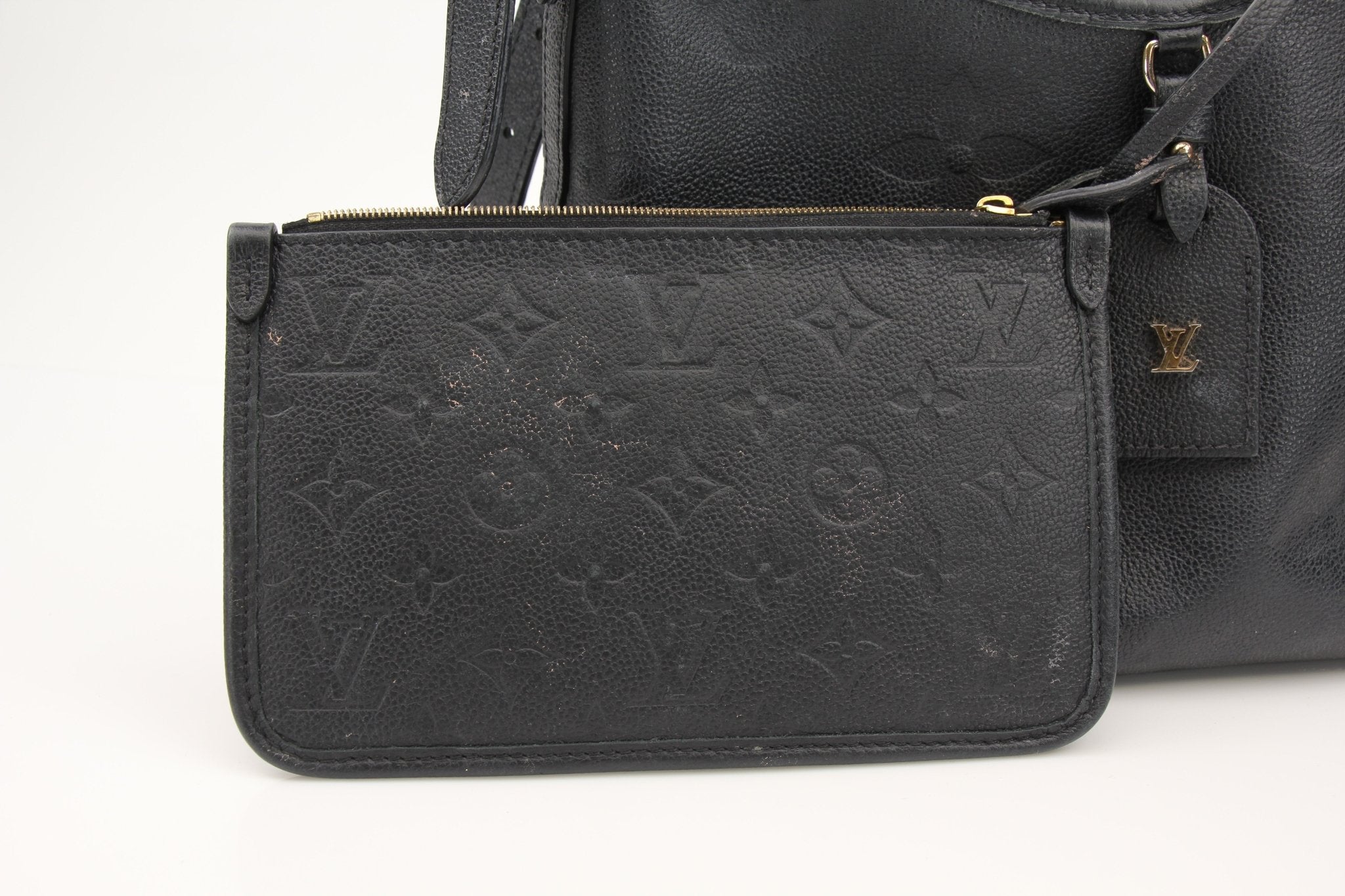 Gold & Beyond Louis Vuitton Carryall PM handbag with leather handles and monogram canvas, displayed on a neutral background.